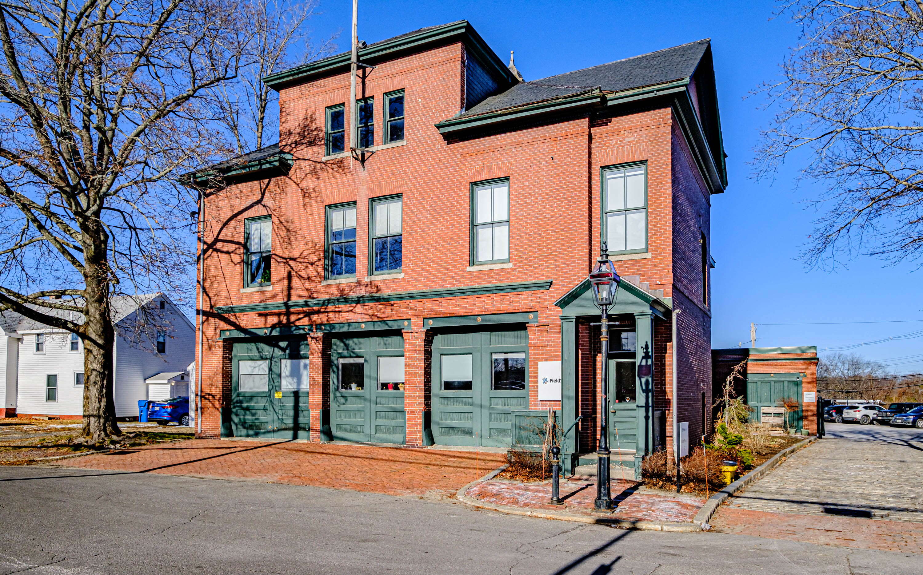 brick building with large green doors