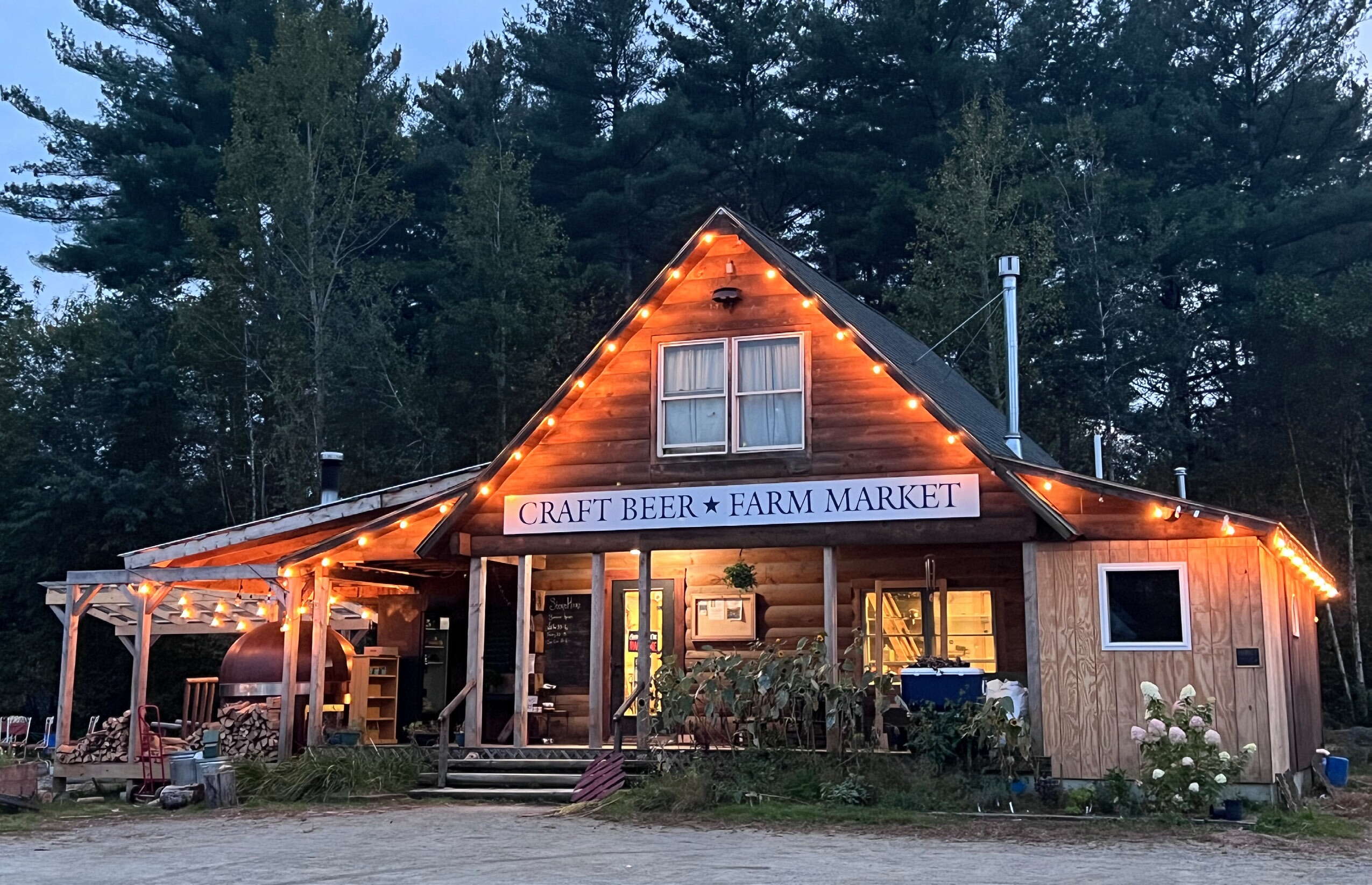 wood building with sign and strings of lights