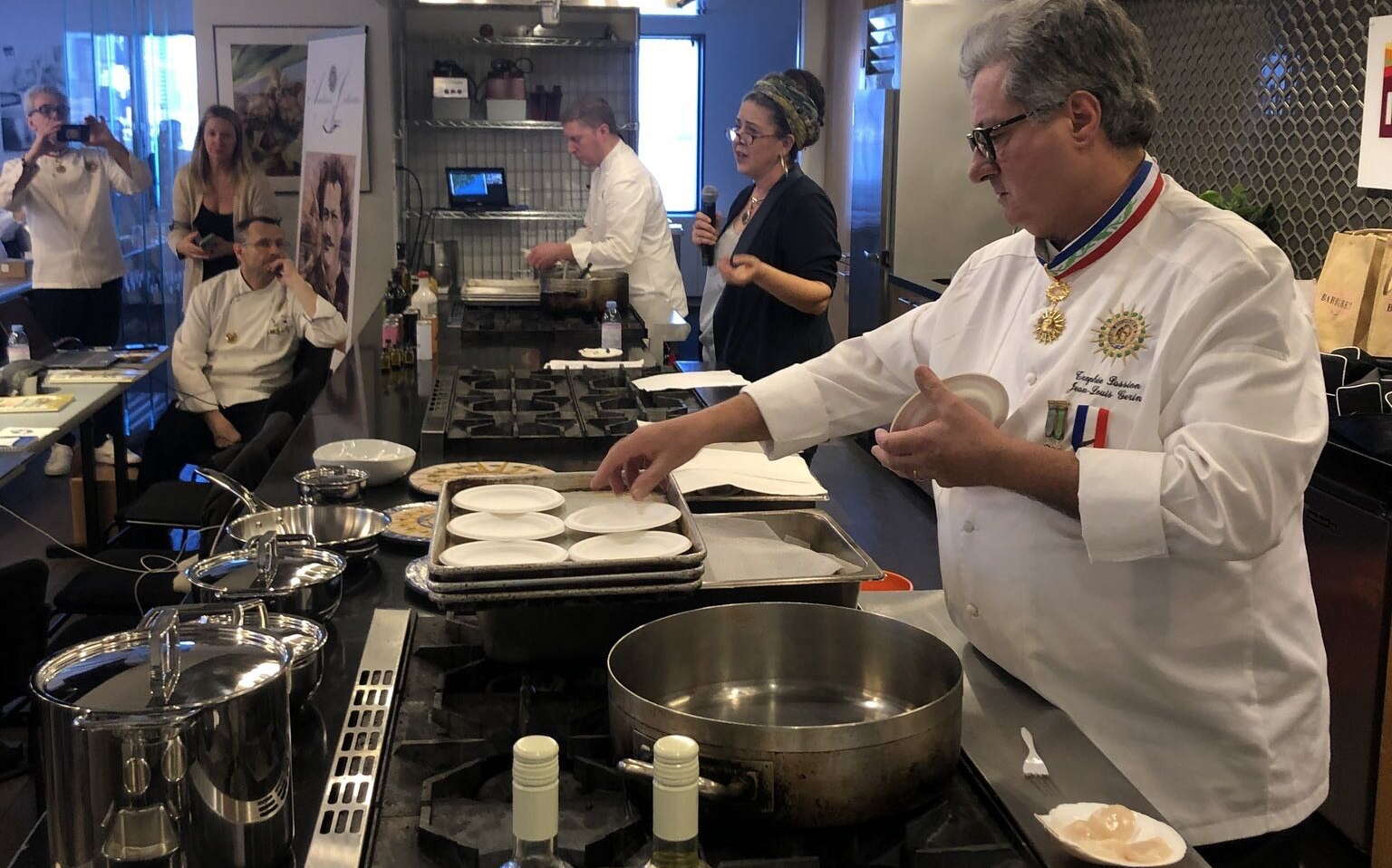 people in galley with shellfish and pans