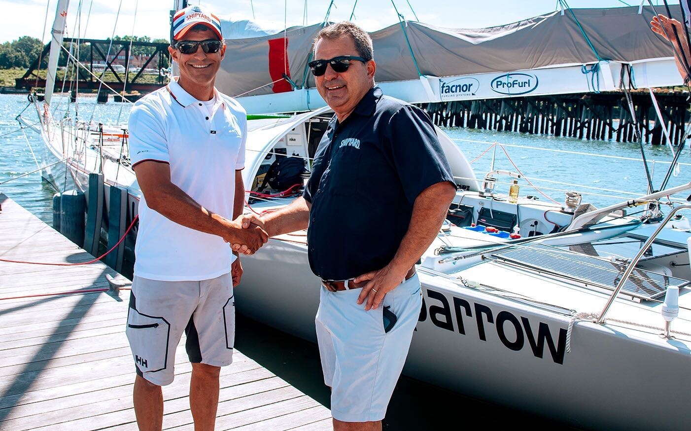 2 people shaking hands and boat