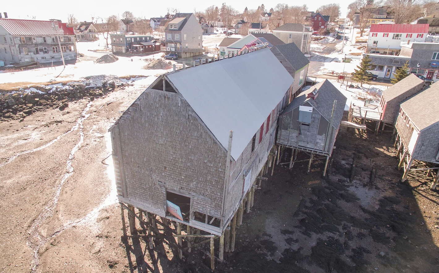 buildings on piling over mud