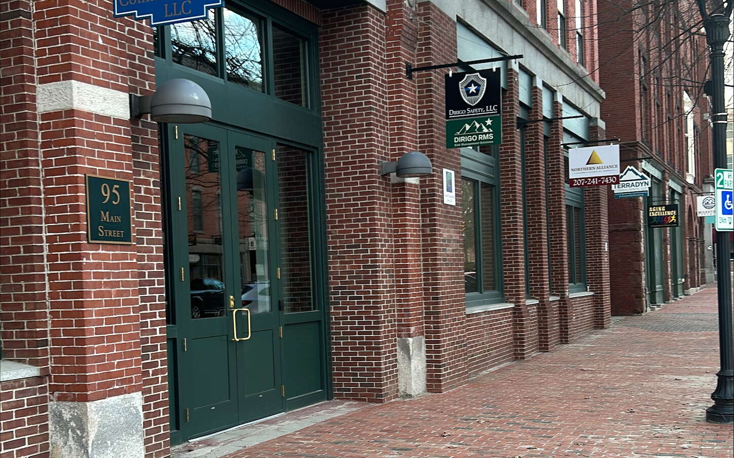 brick building with signs and brick sidewalk