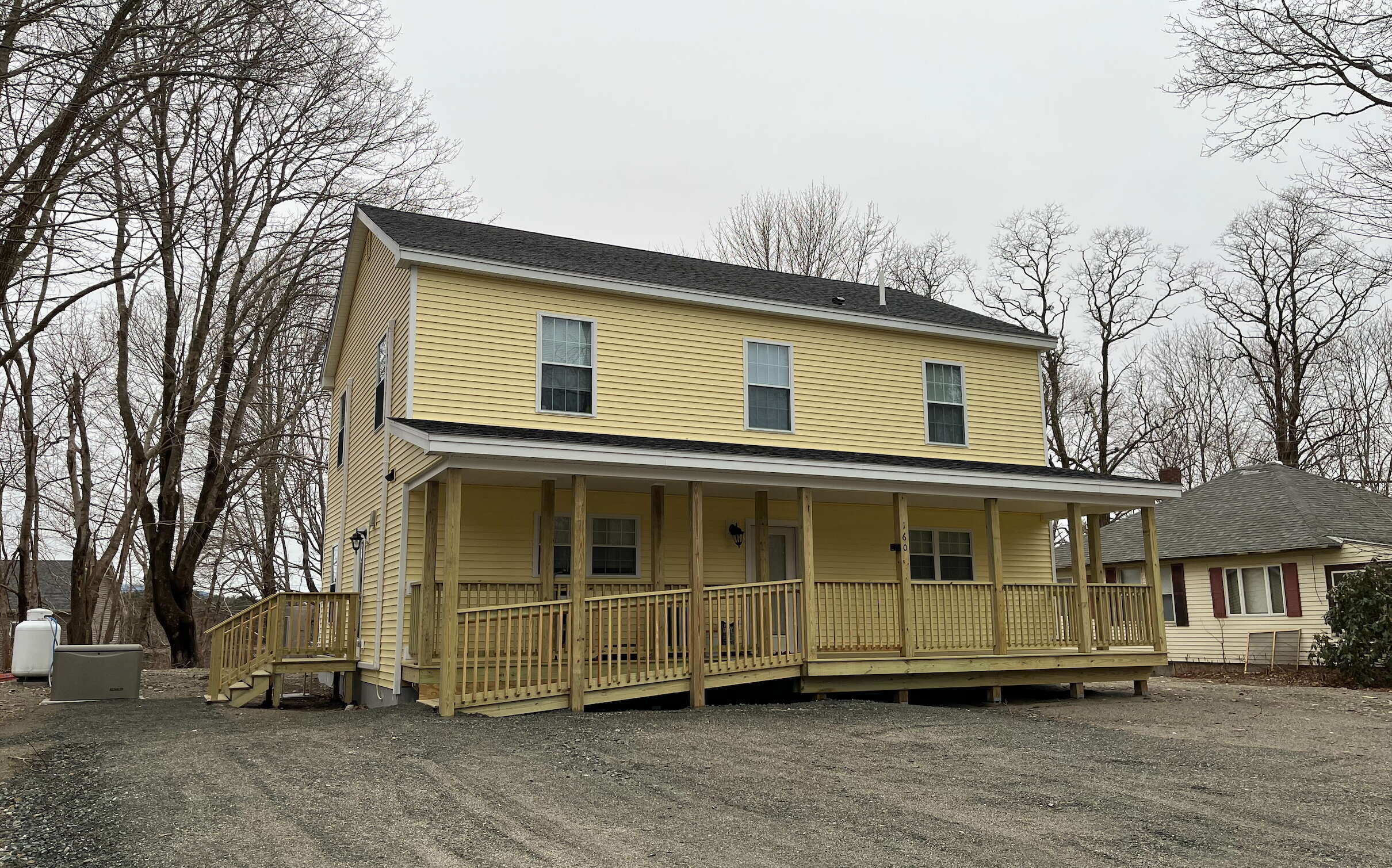 yellow building with ramp and sandy ground