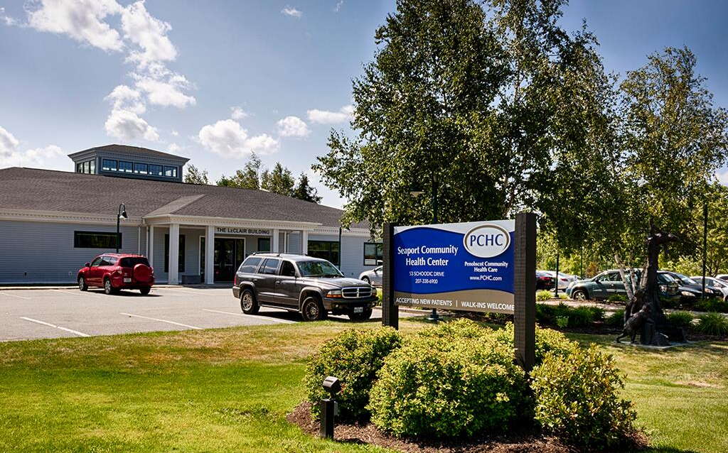 building, sign, parking lot and lawn