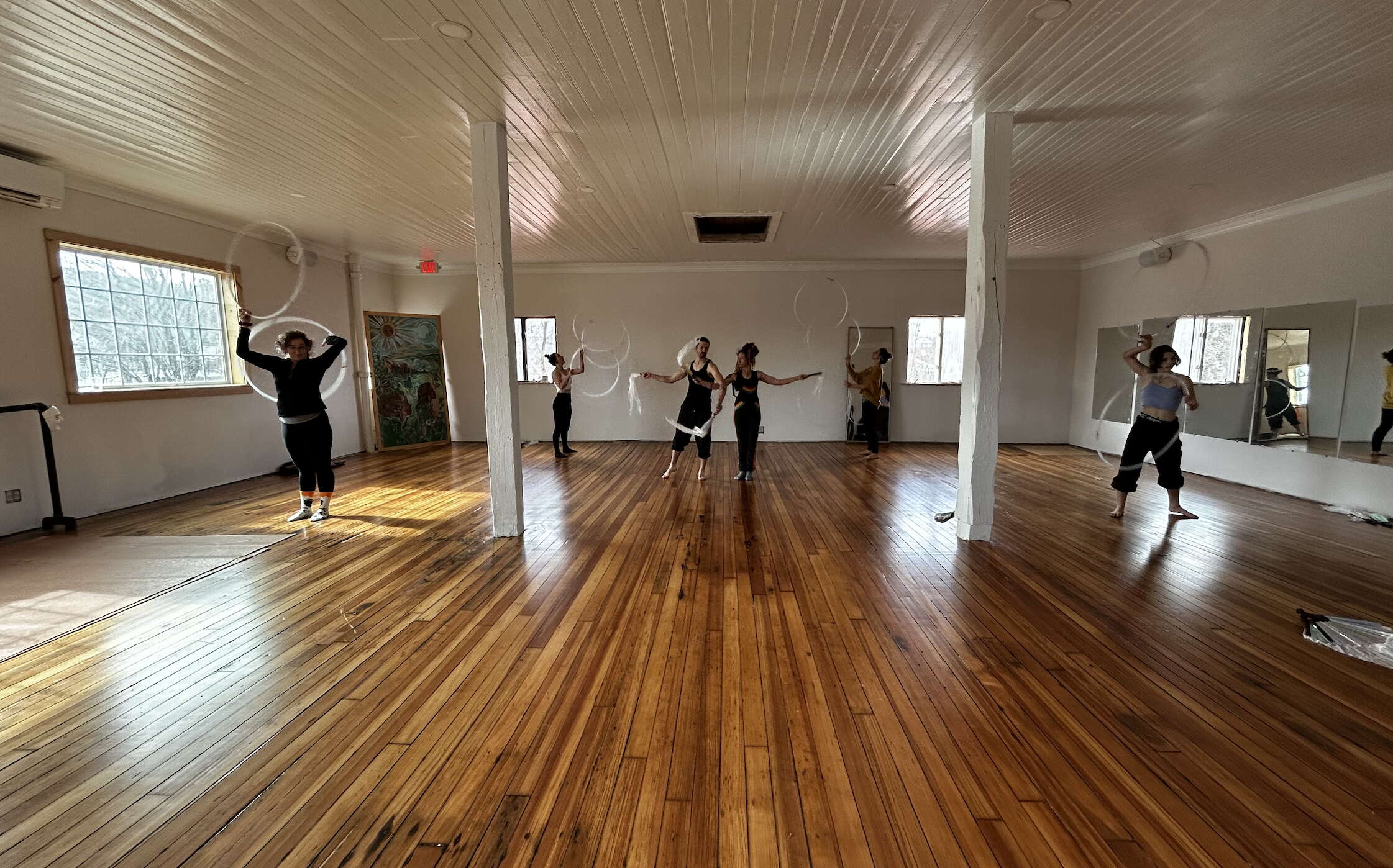 big room with shiny wood floor and people