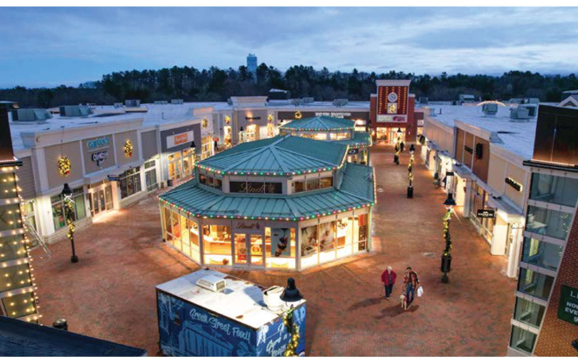 plaza surround by buildings with people walking