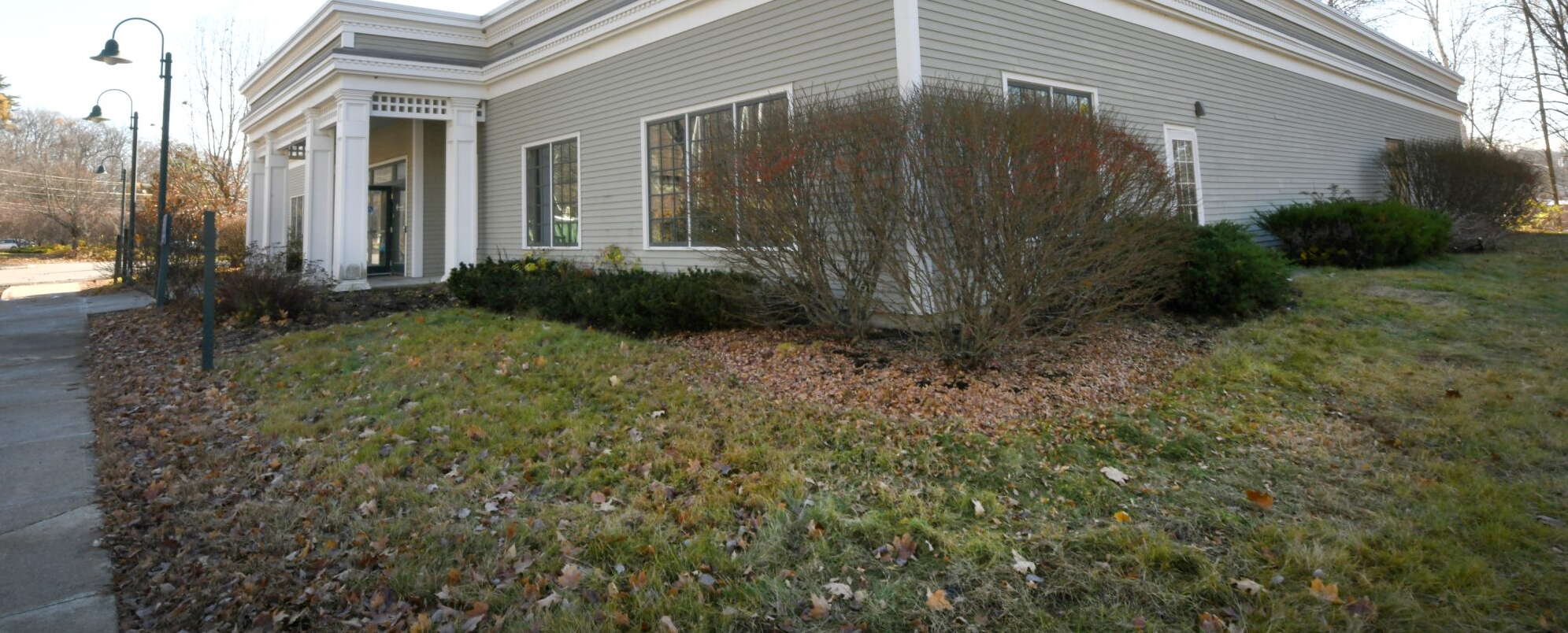 gray sided building and lawn