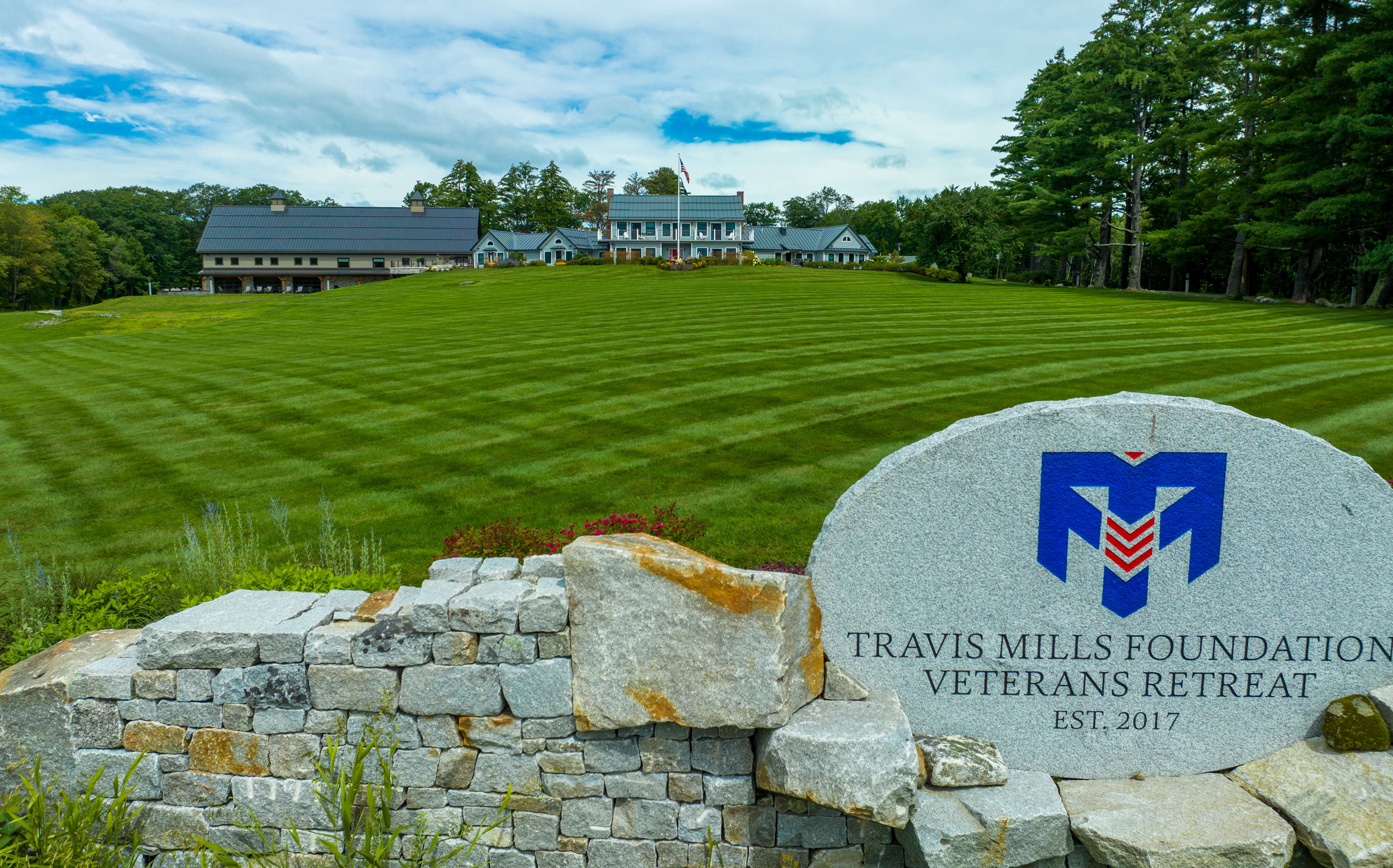 buildings in background with lawn and sign in foreground