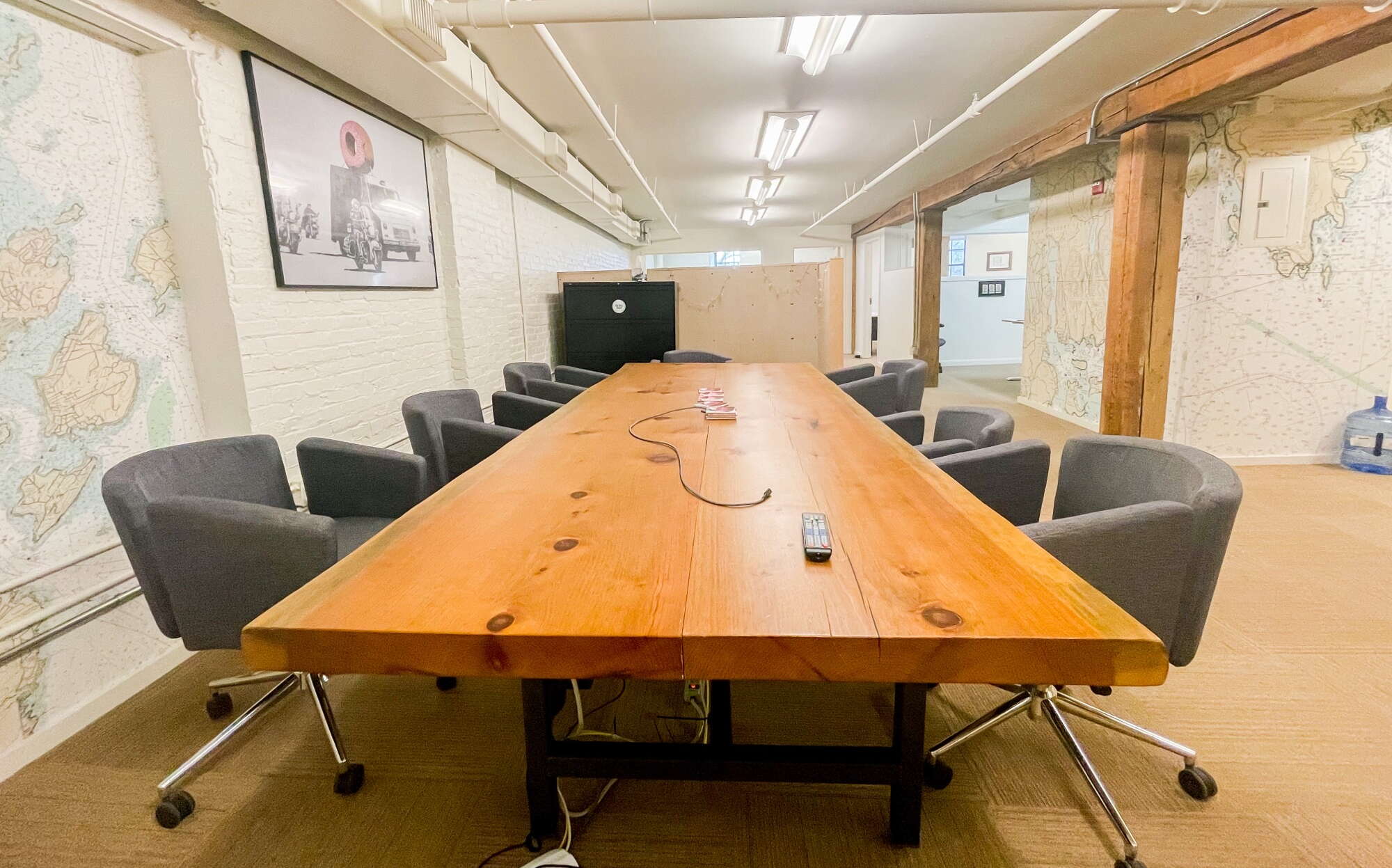 room with long wood table and gray chairs