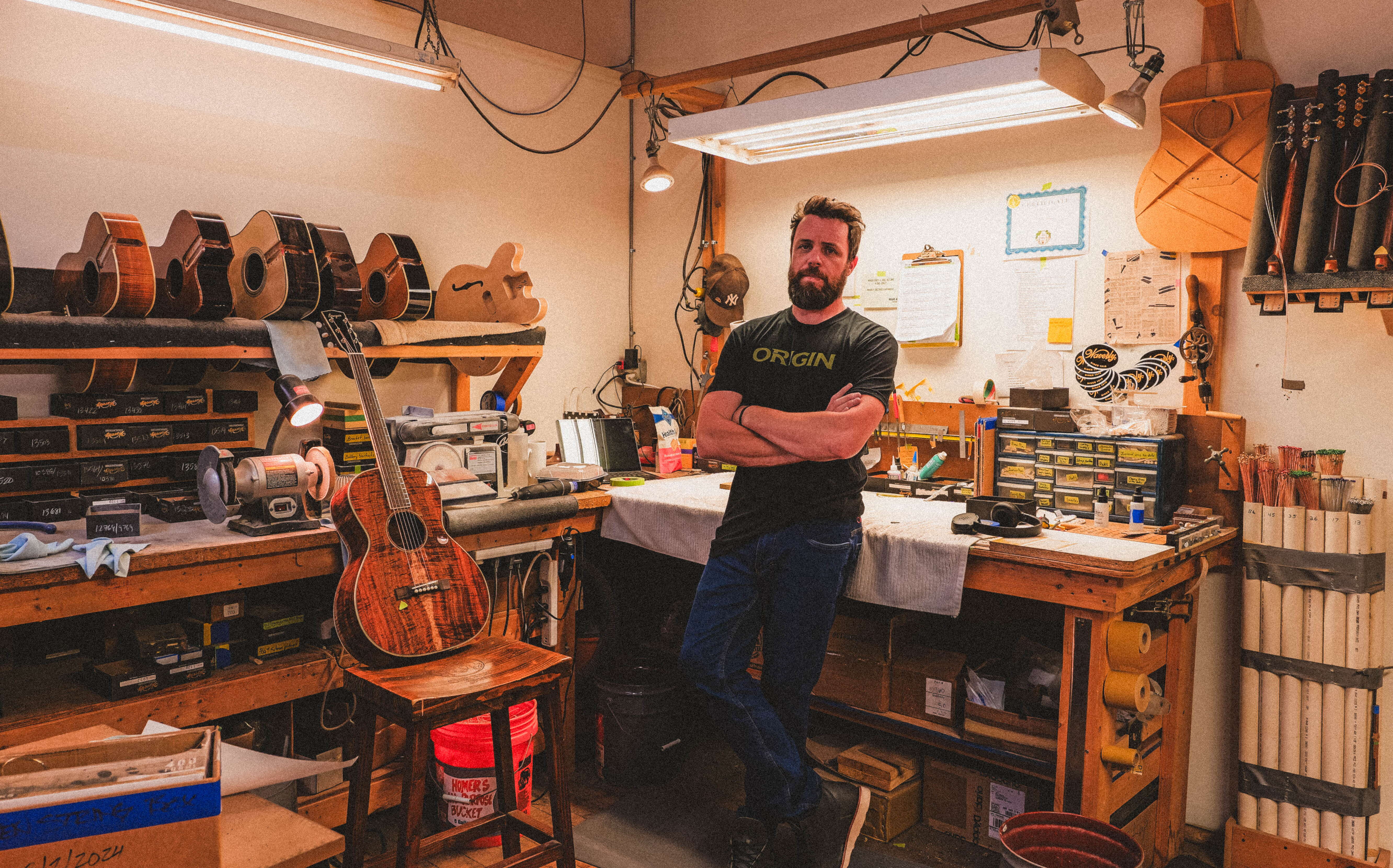 A Bourgeois employee stands in a guitar-making workshop.