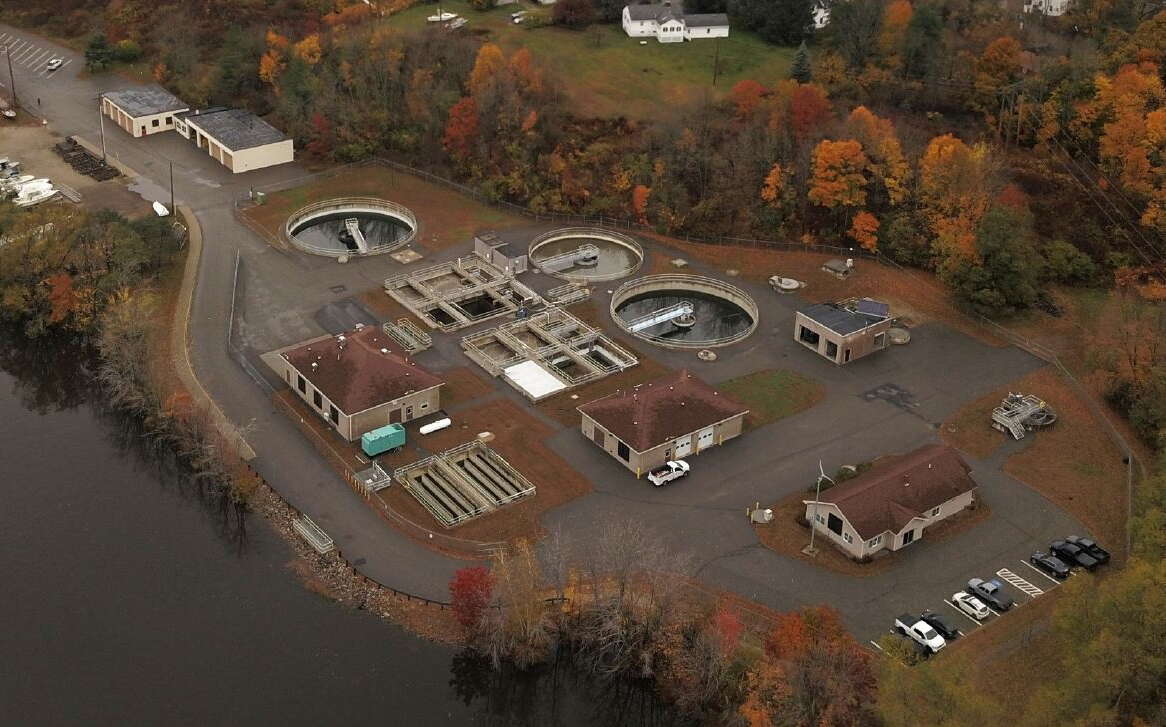 This aerial view shows a treatment plant next to a river.