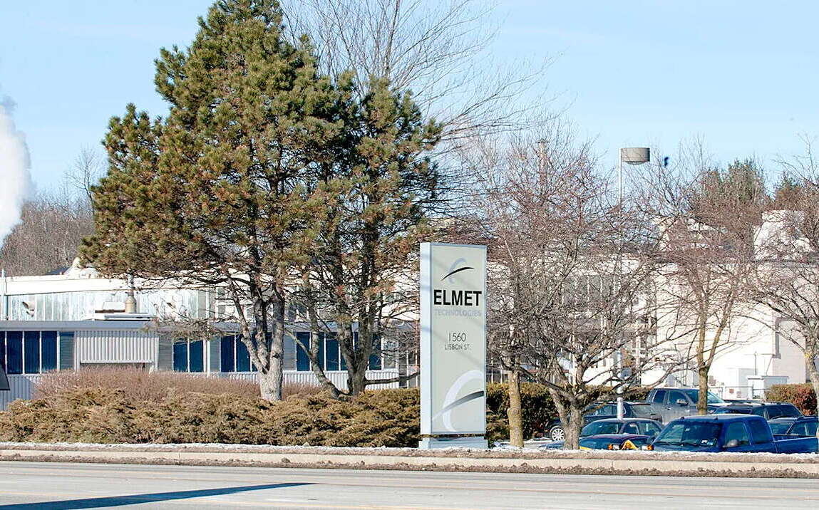 Elmet's building with a sign out front.