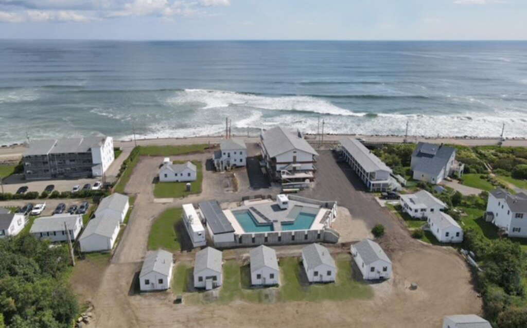 An aerial view of hotel buildings by the beach.
