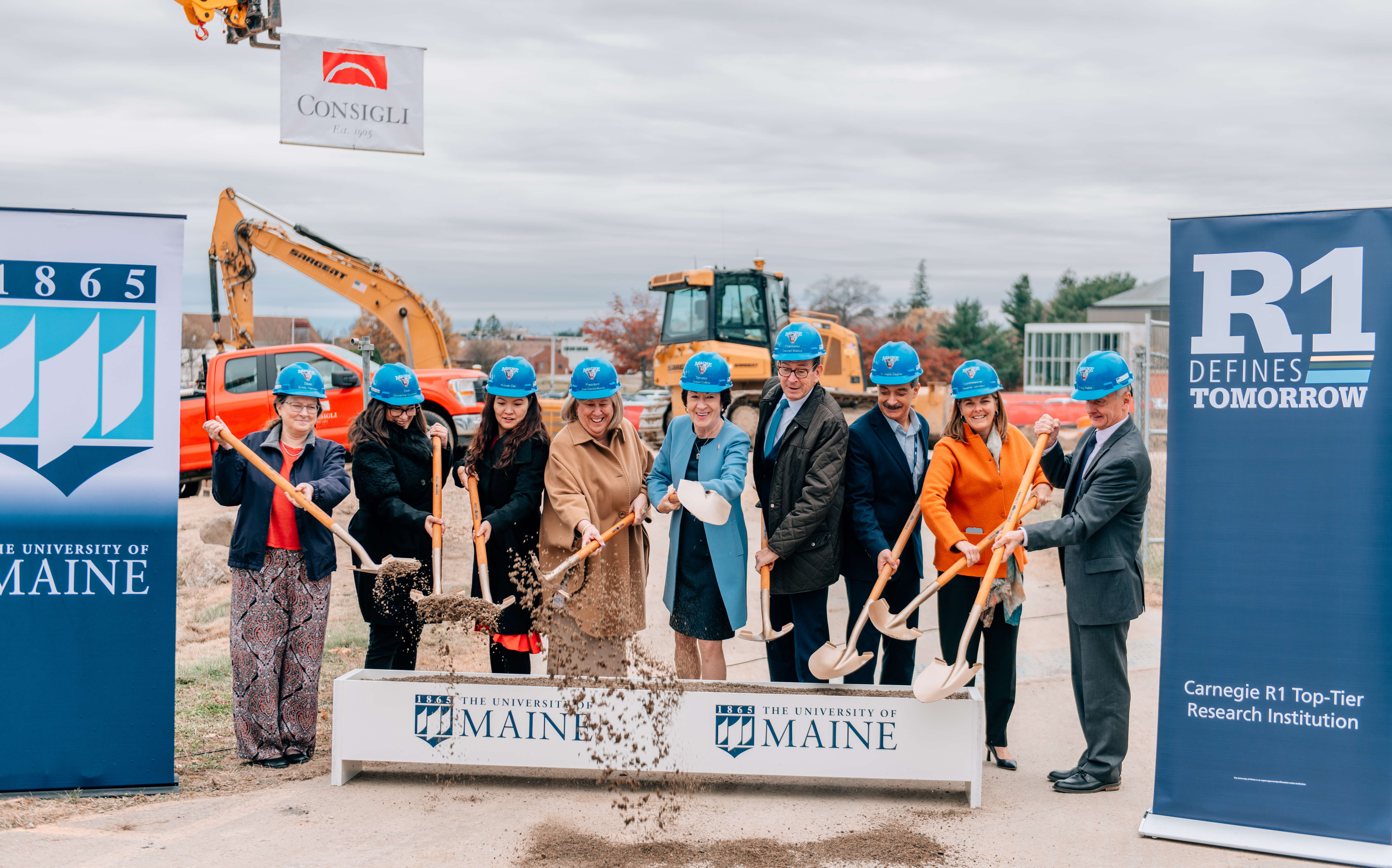 People pose with shovels at a groundbreaking ceremony.