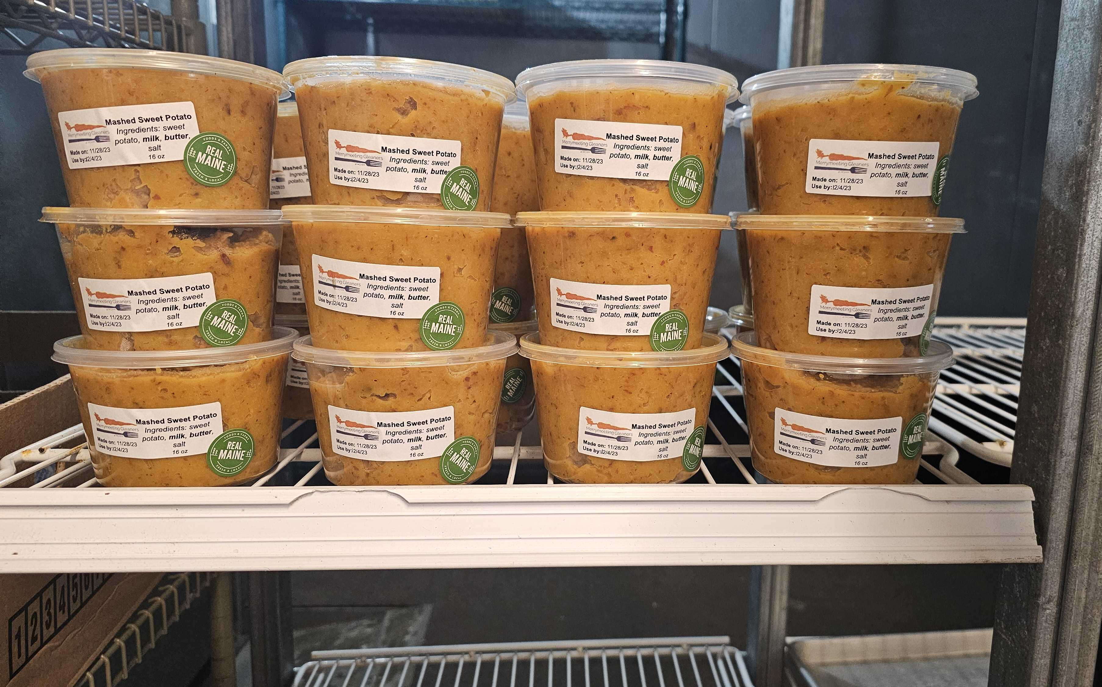stacks of containers are in a fridge.