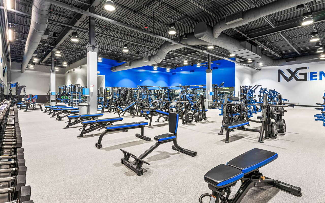A gym room is full of exercise equipment.