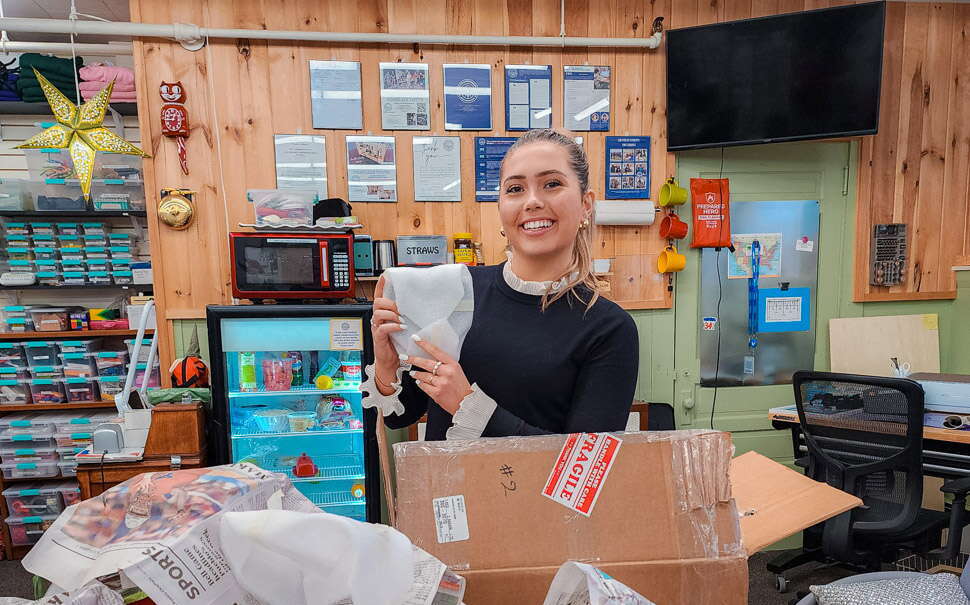 A person is in a store and holds up an object.
