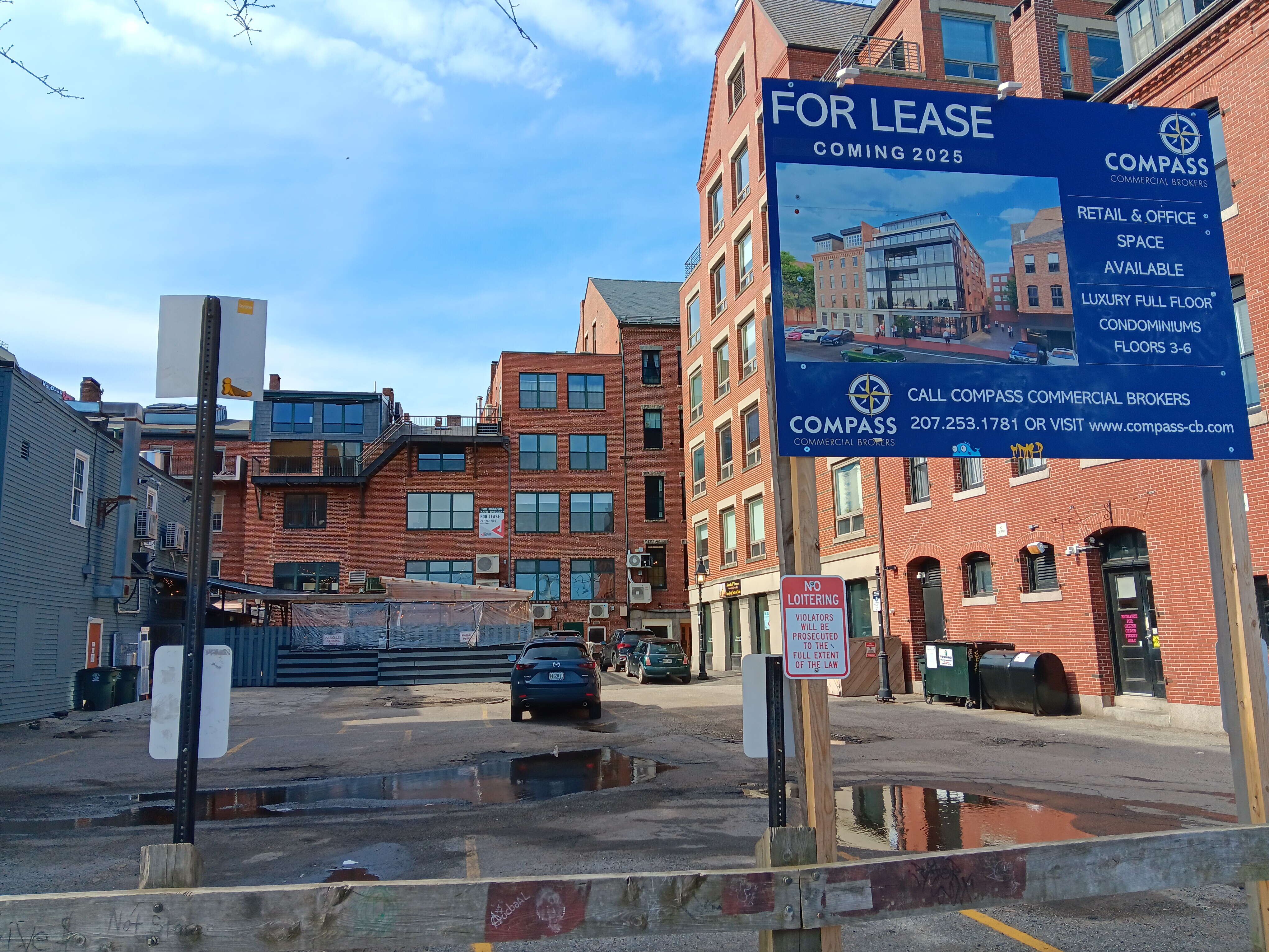 parking lot with project sign