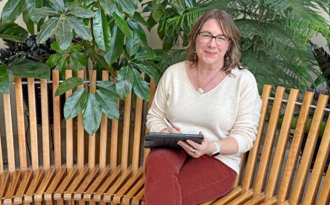 A person sits on a bench.