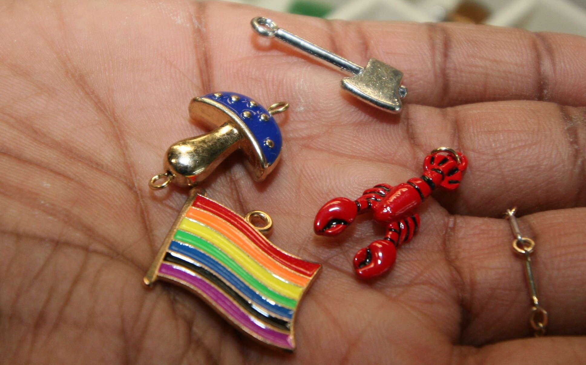 A hand holds colorful small objects.