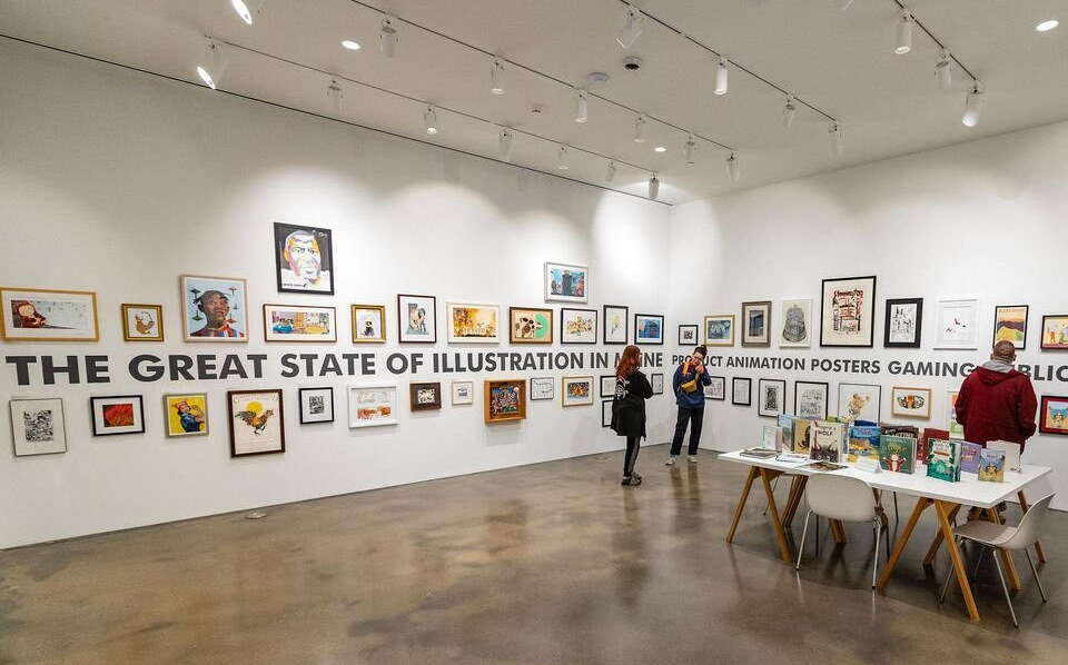 A room has a table and artworks on the walls.