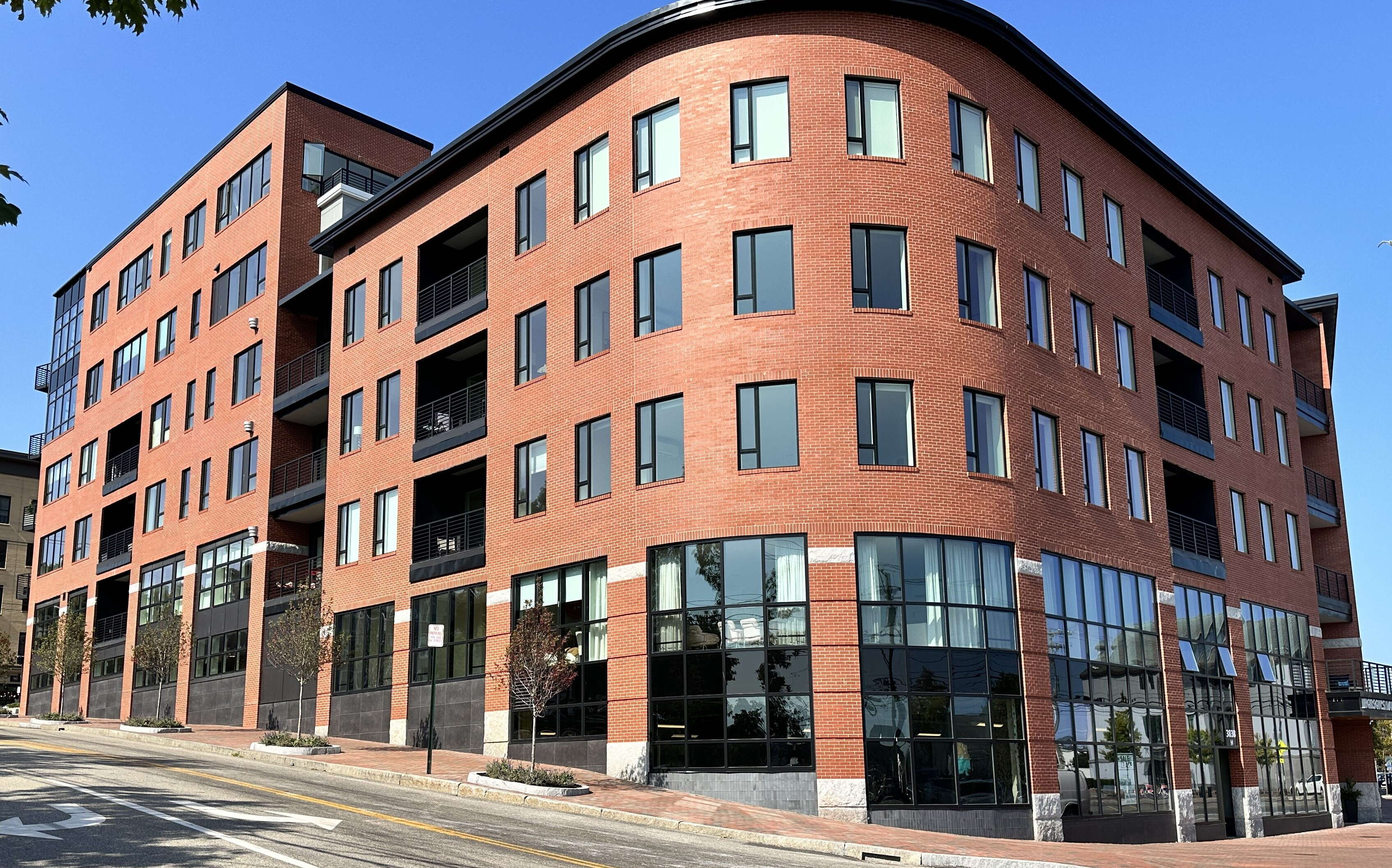 A brick building has a rounded corner.