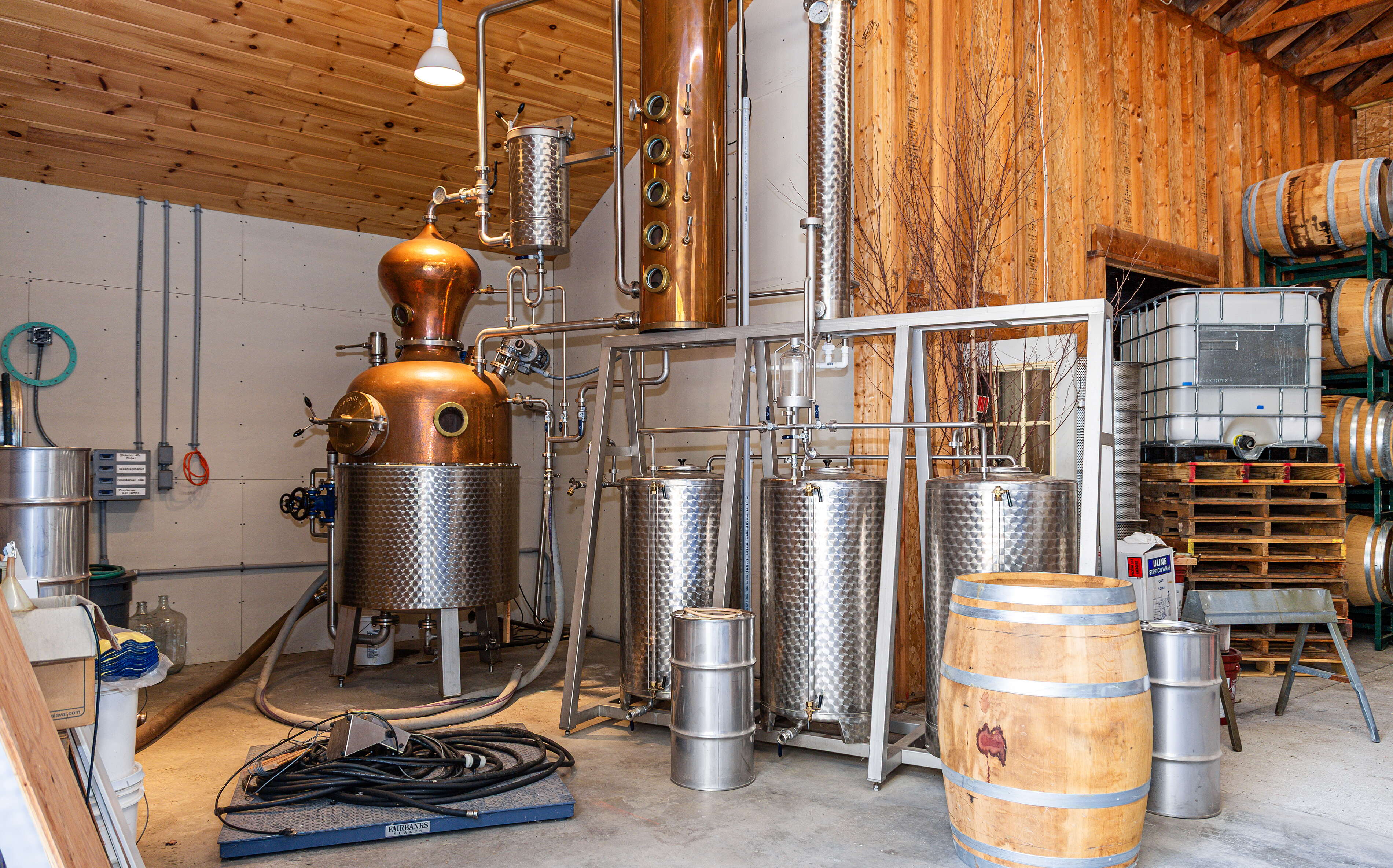 A room has machinery and a barrel.