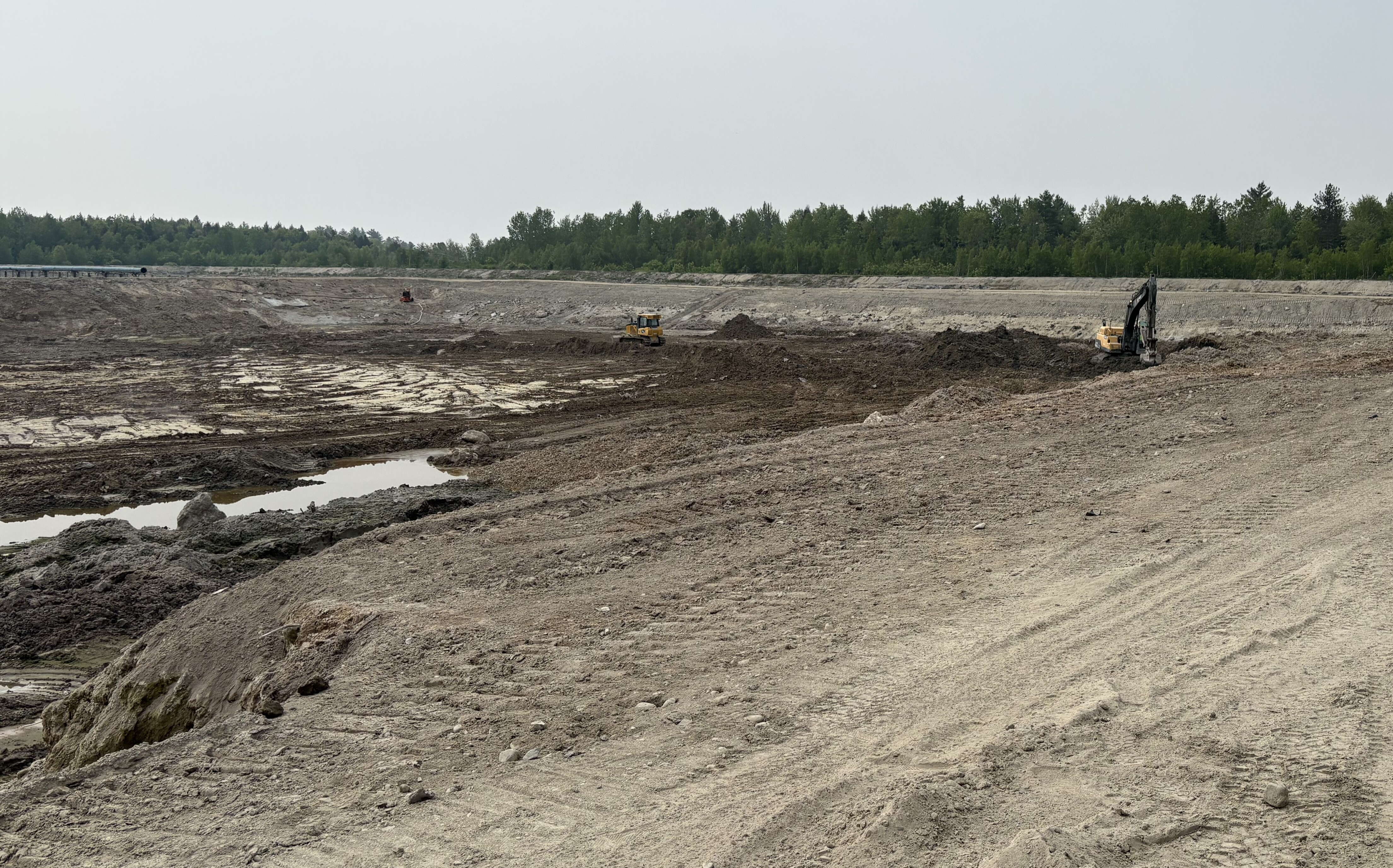 A view of land that's muddy and rutted.