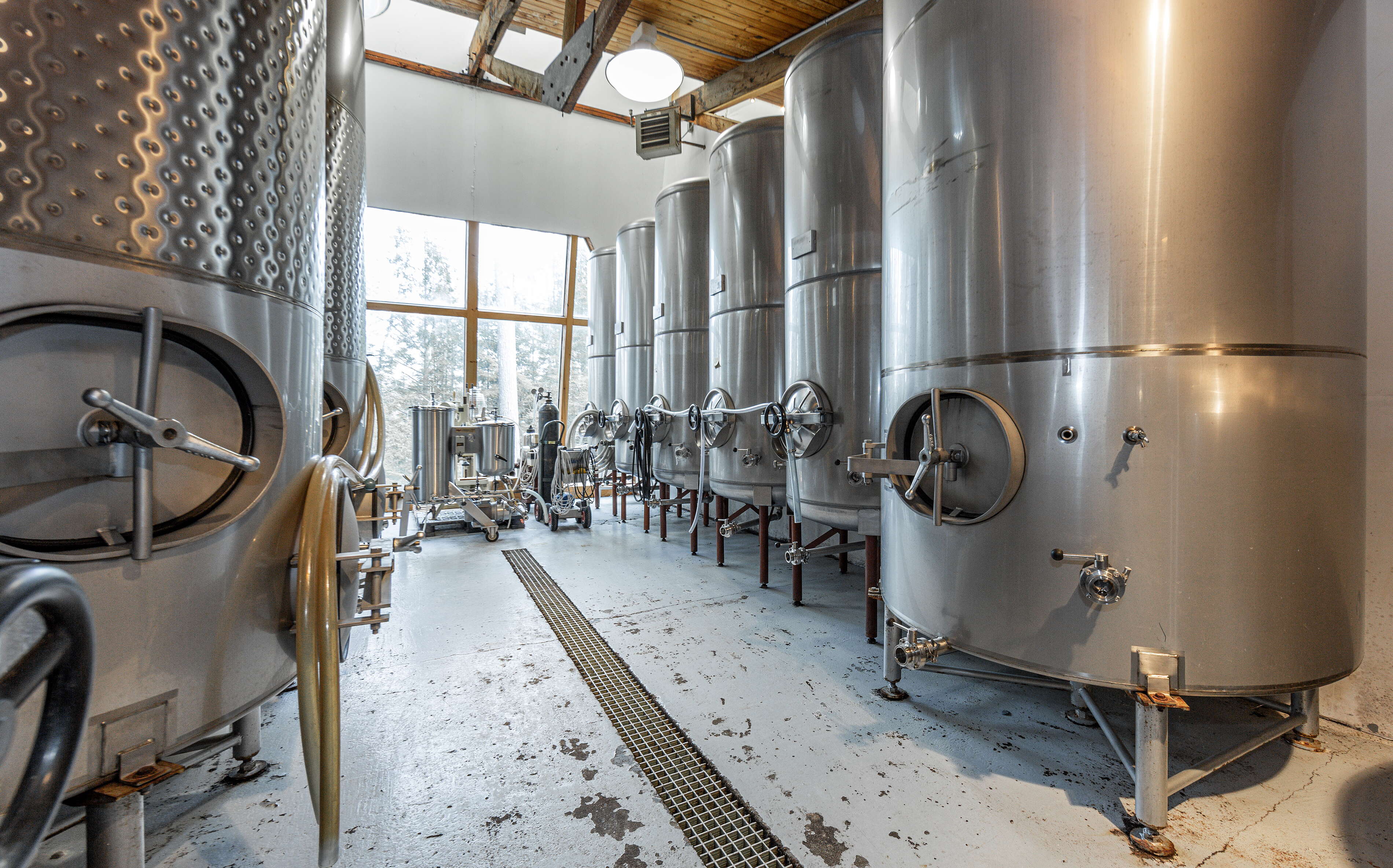 A room has rows of large tanks.