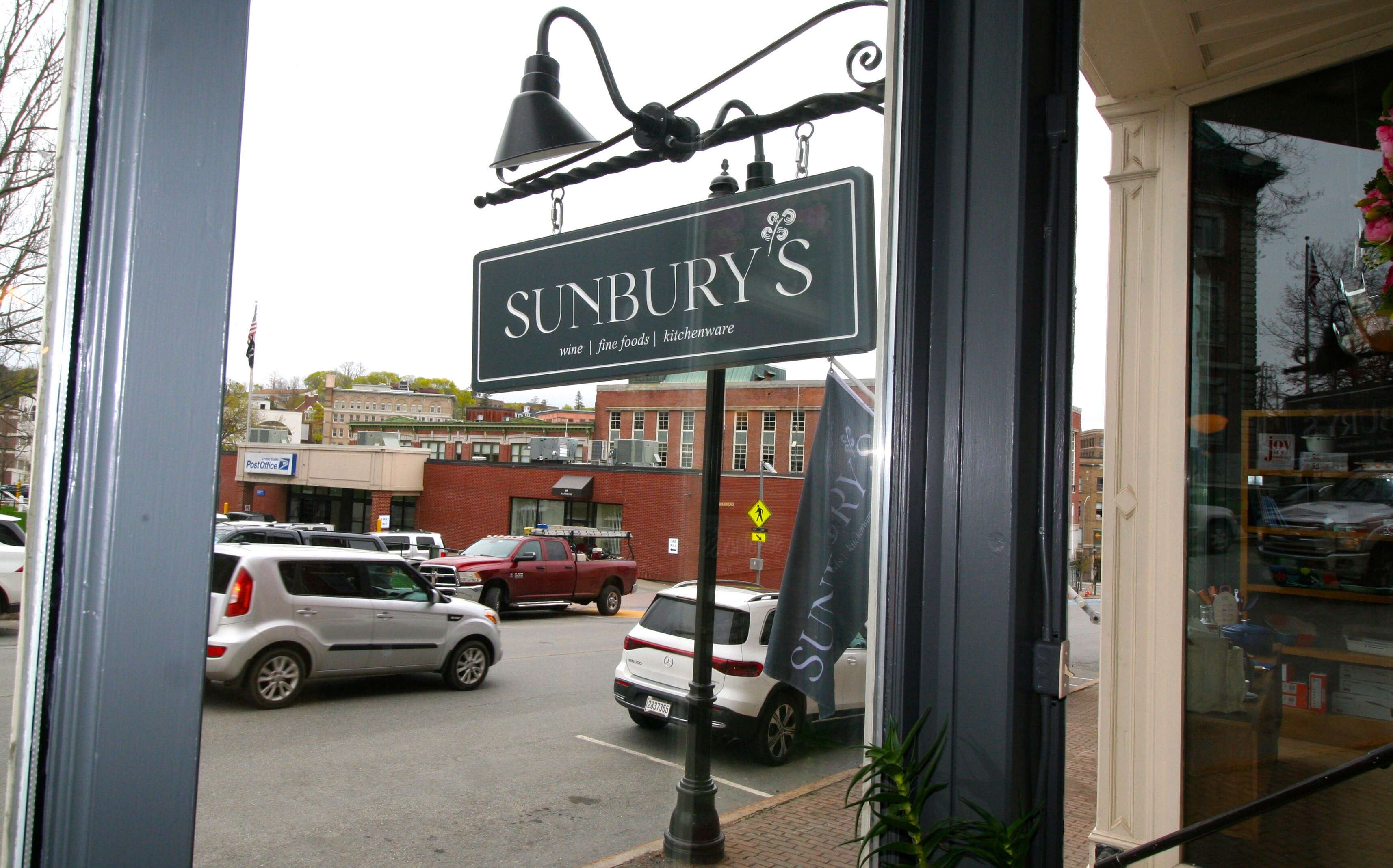 A sign is seen through a window.