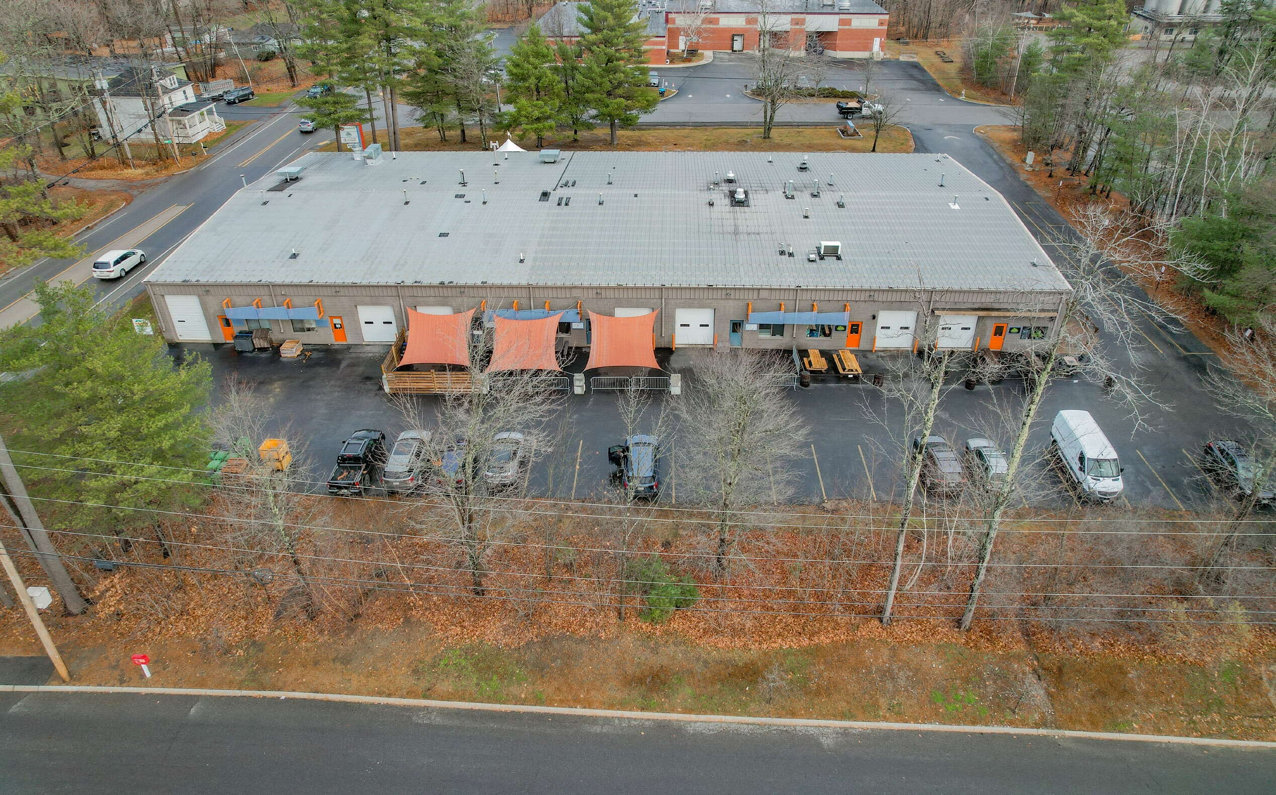 An aerial view shows a long, low buliding.