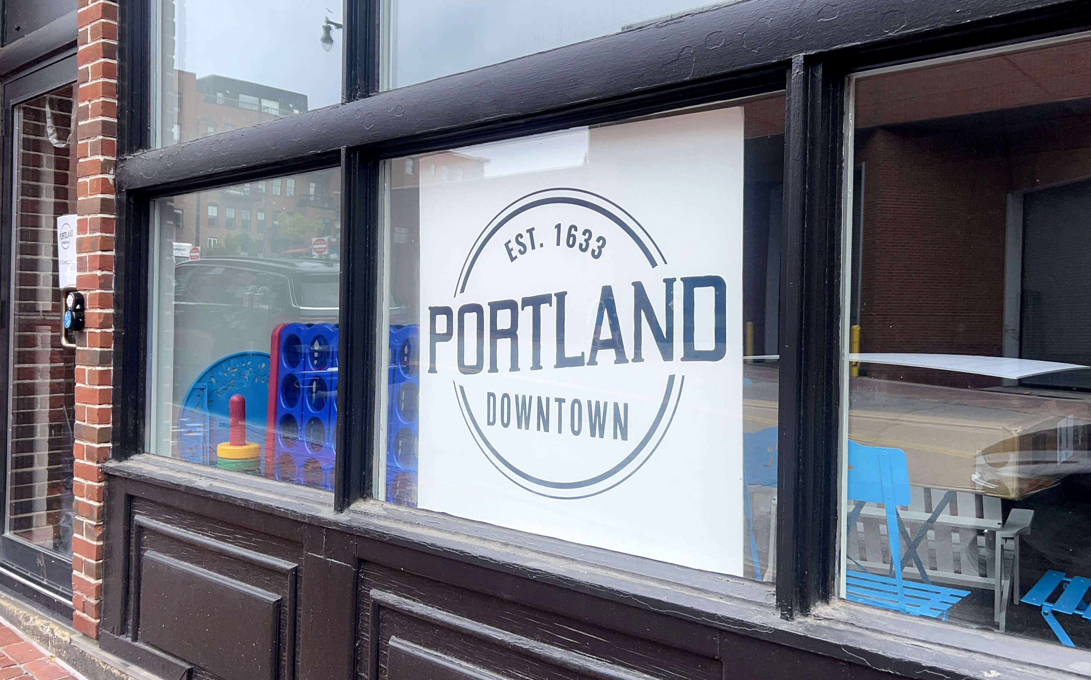An exterior view of a storefront with a sign.