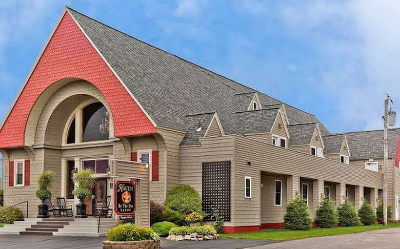 An exterior view of a building with a sharply peaked roof.
