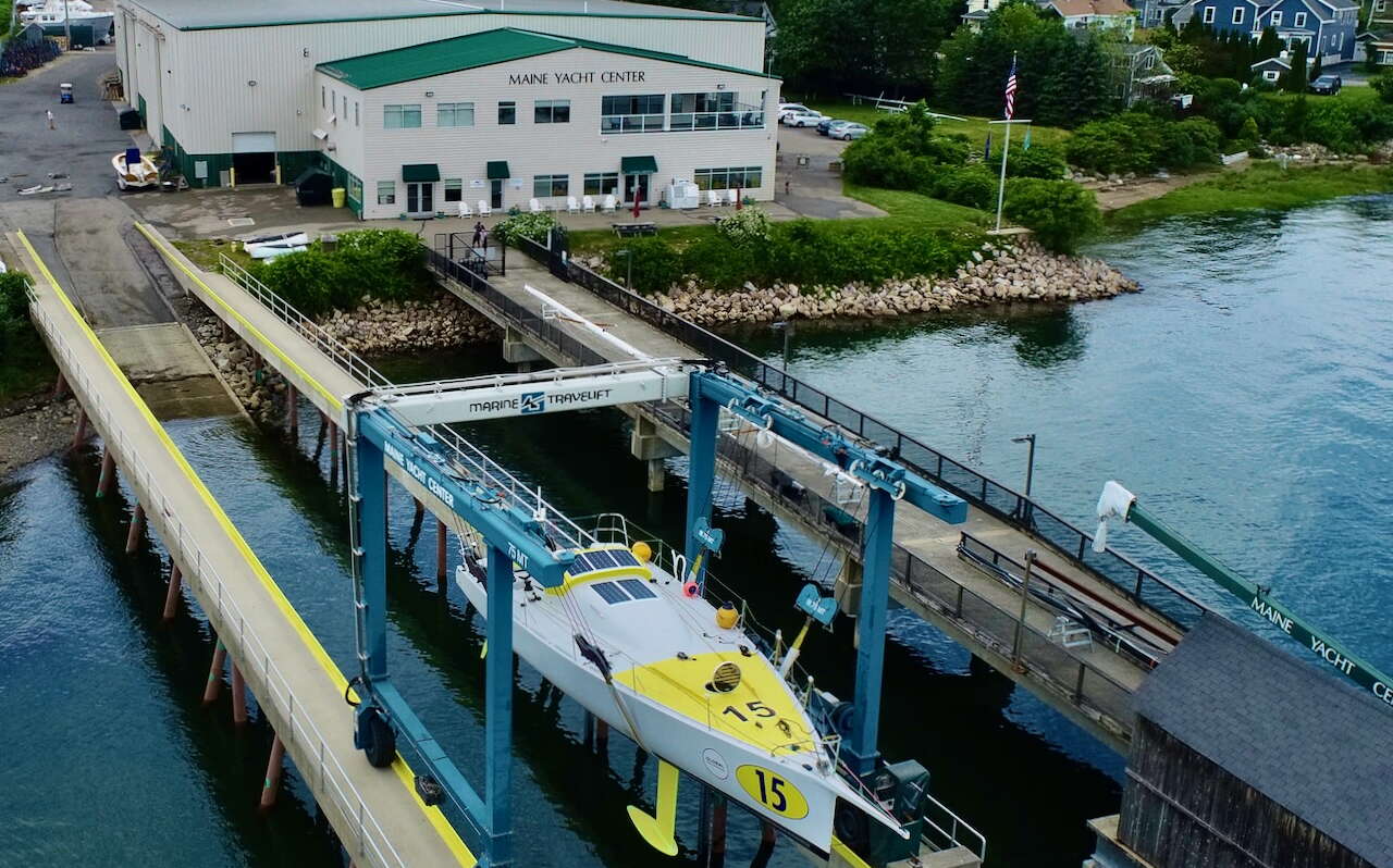 An aerial view shows a boat and a building.