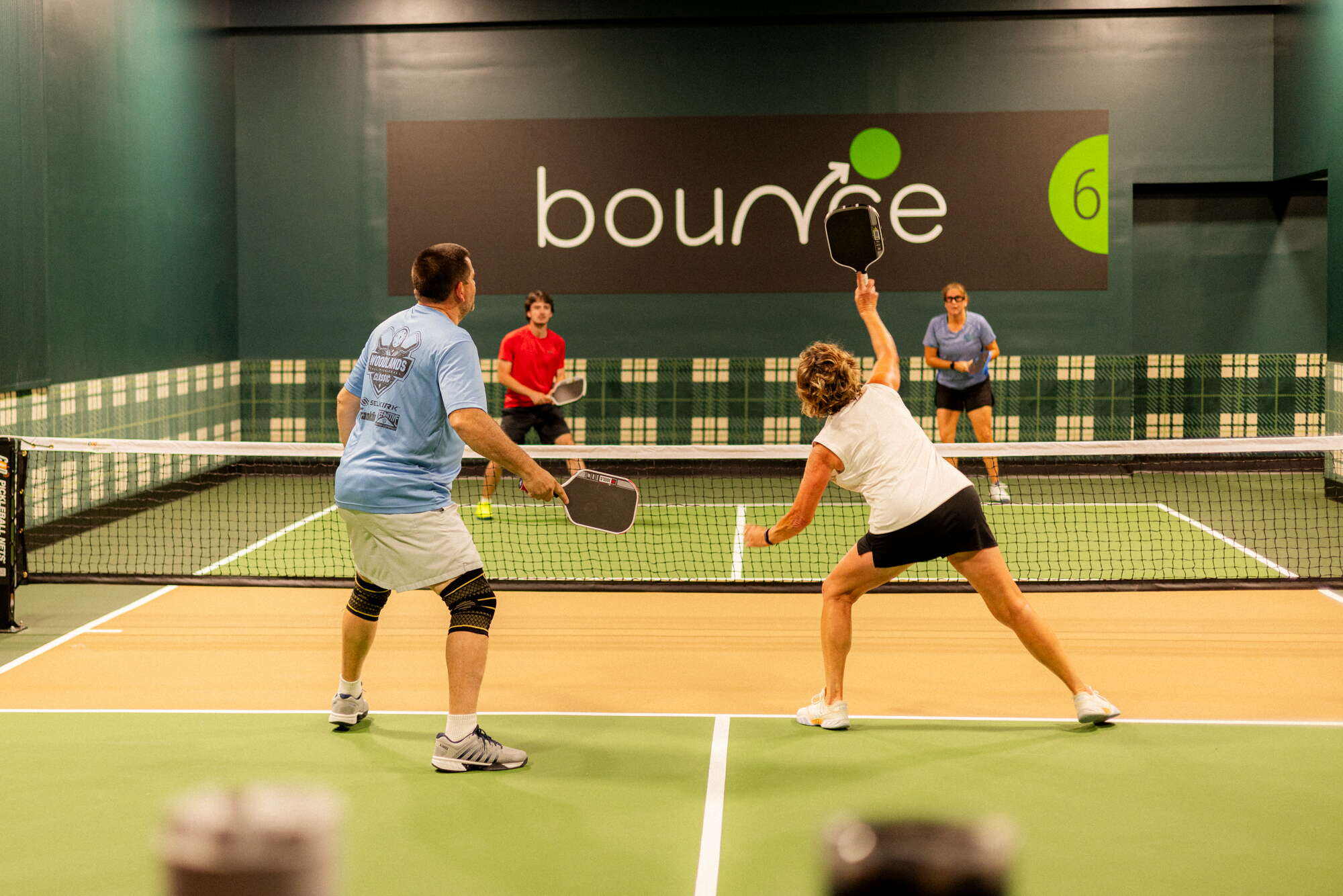 four pickleball players