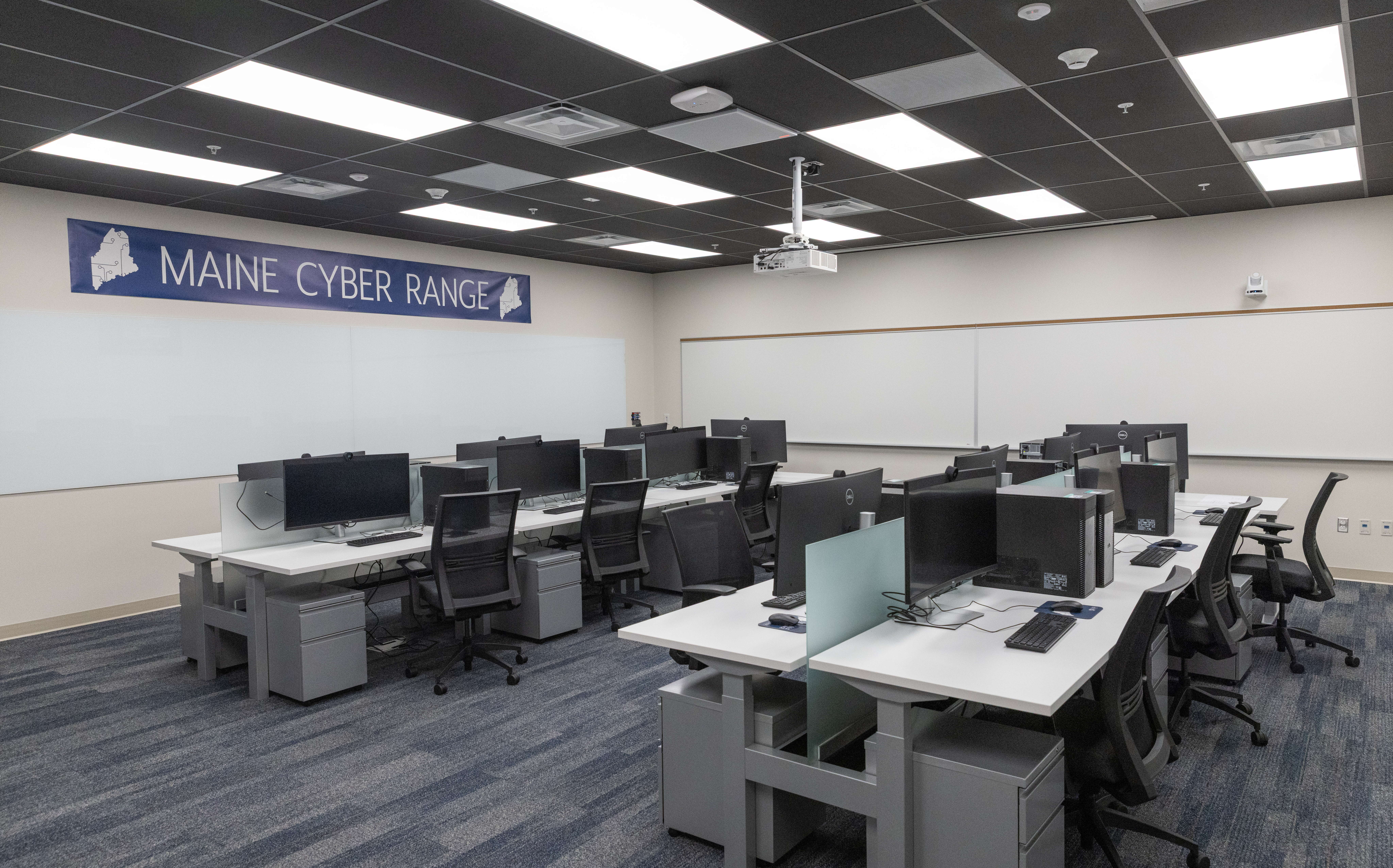A room is full of desks and computers.