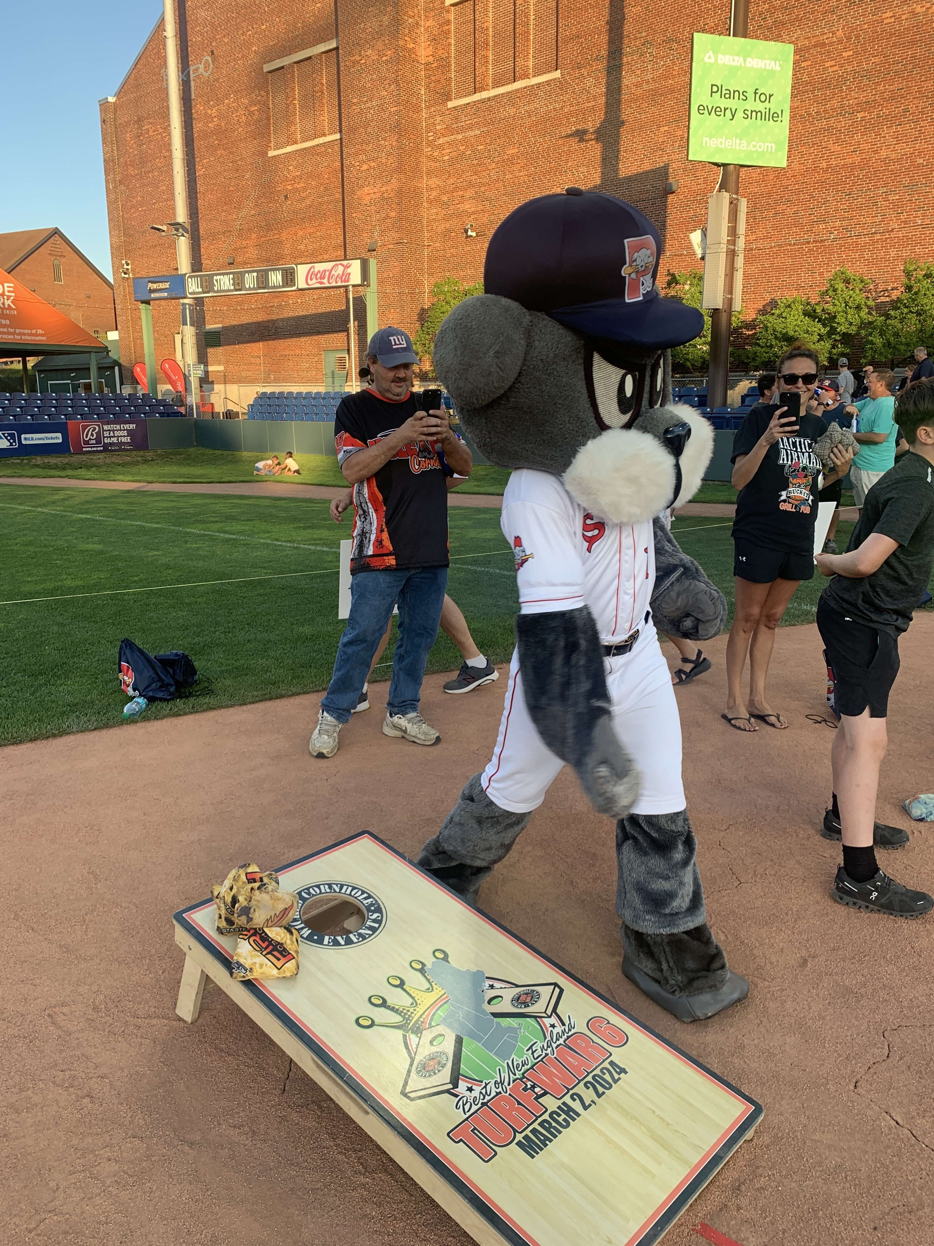 Mascot Slugger playing cornhole  