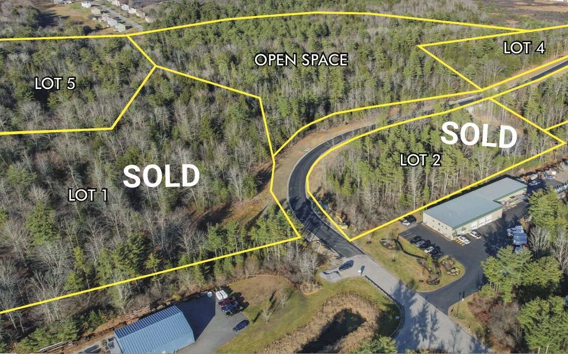 An aerial view shows woods and roads overlaid with outlines and words.