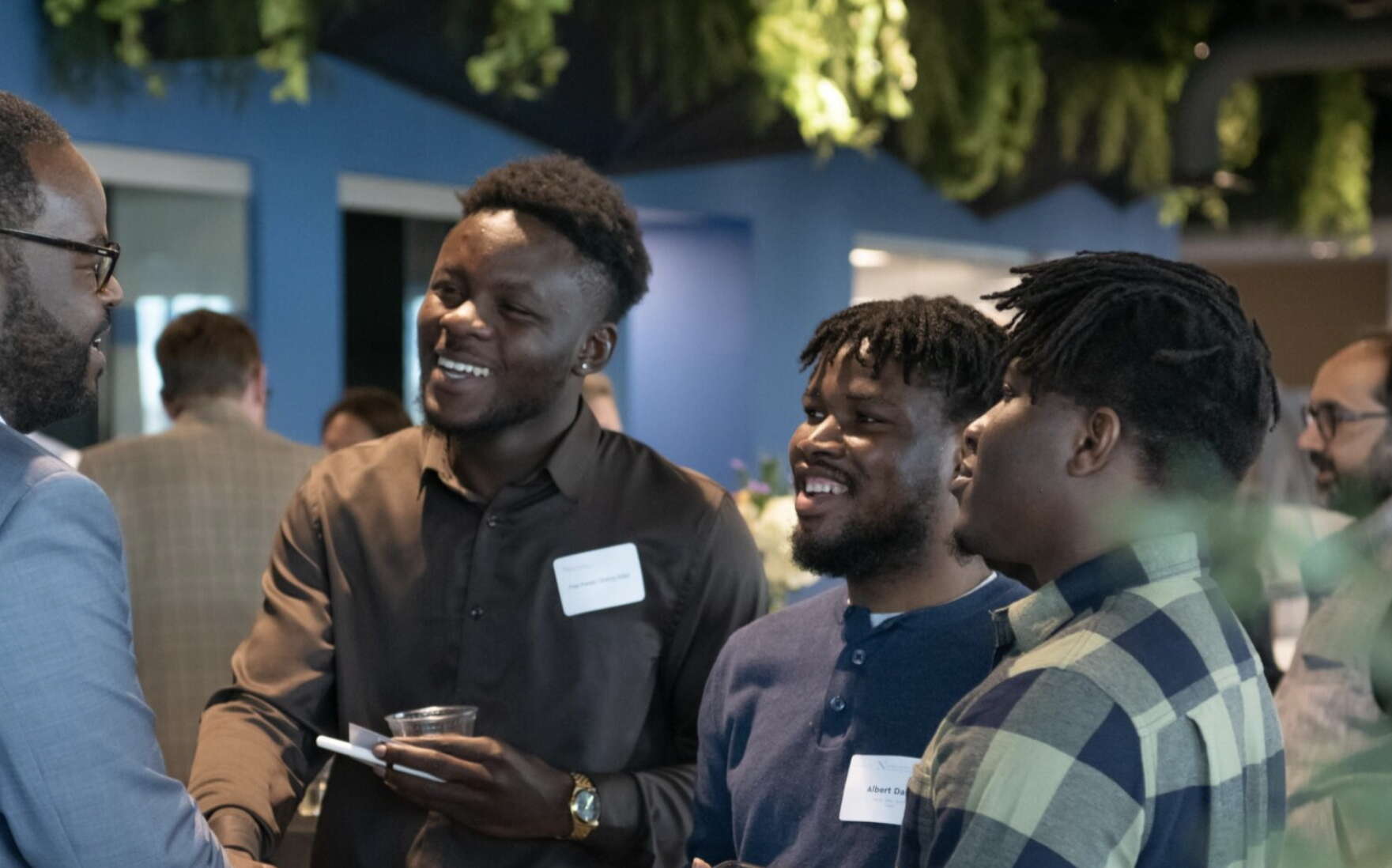 People networking at an event at the Roux Institute in Portland.
