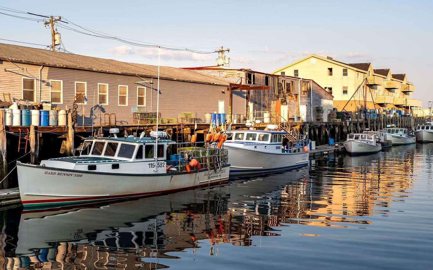 Boats are tied up at a wharf.