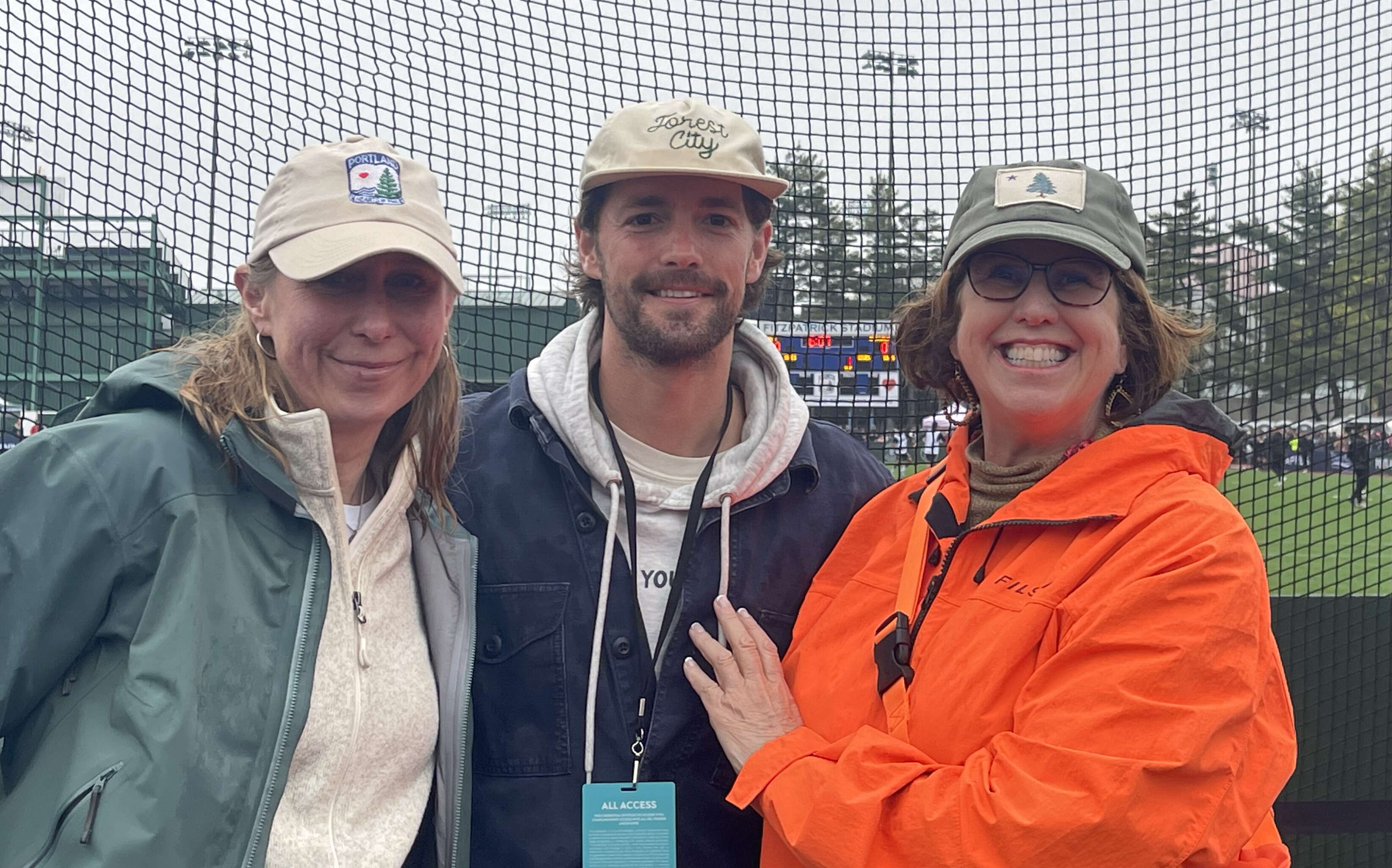 Three people at a Hearts of Pine soccer game.