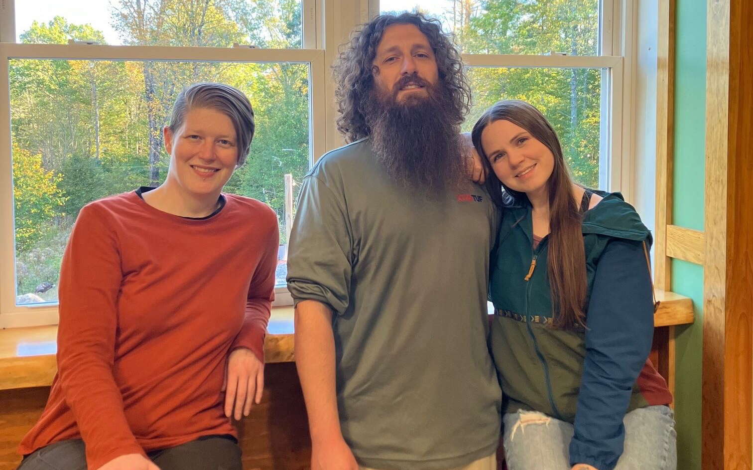 Three people pose for a photo.