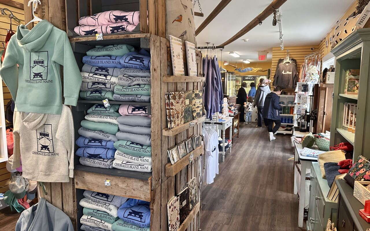a room has shelves and clothes.