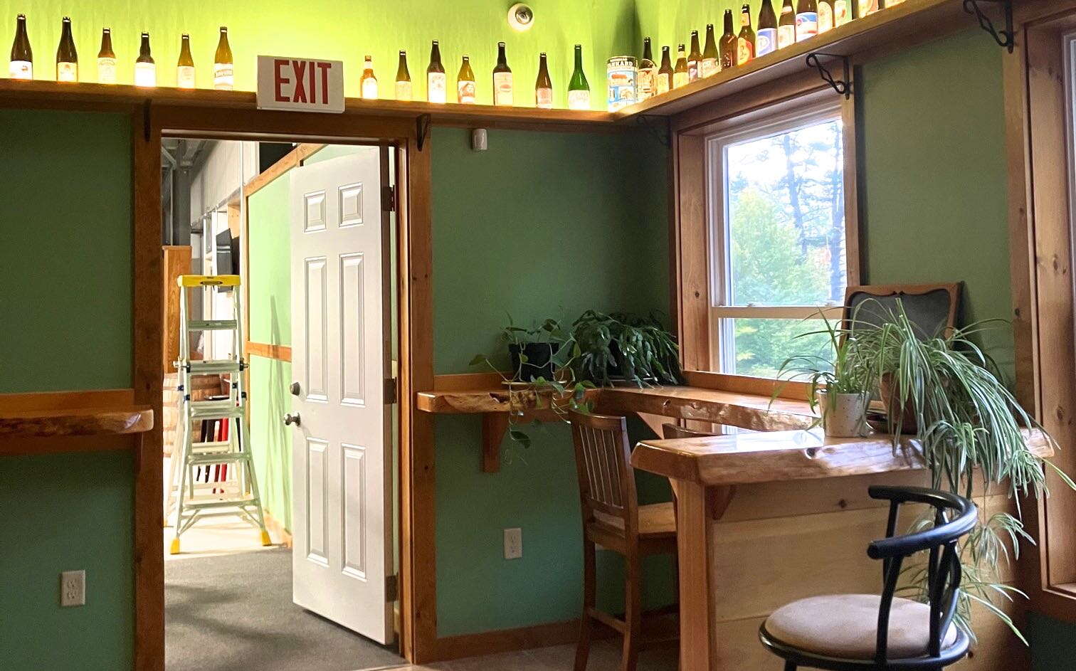 A room has green walls and furnishings.