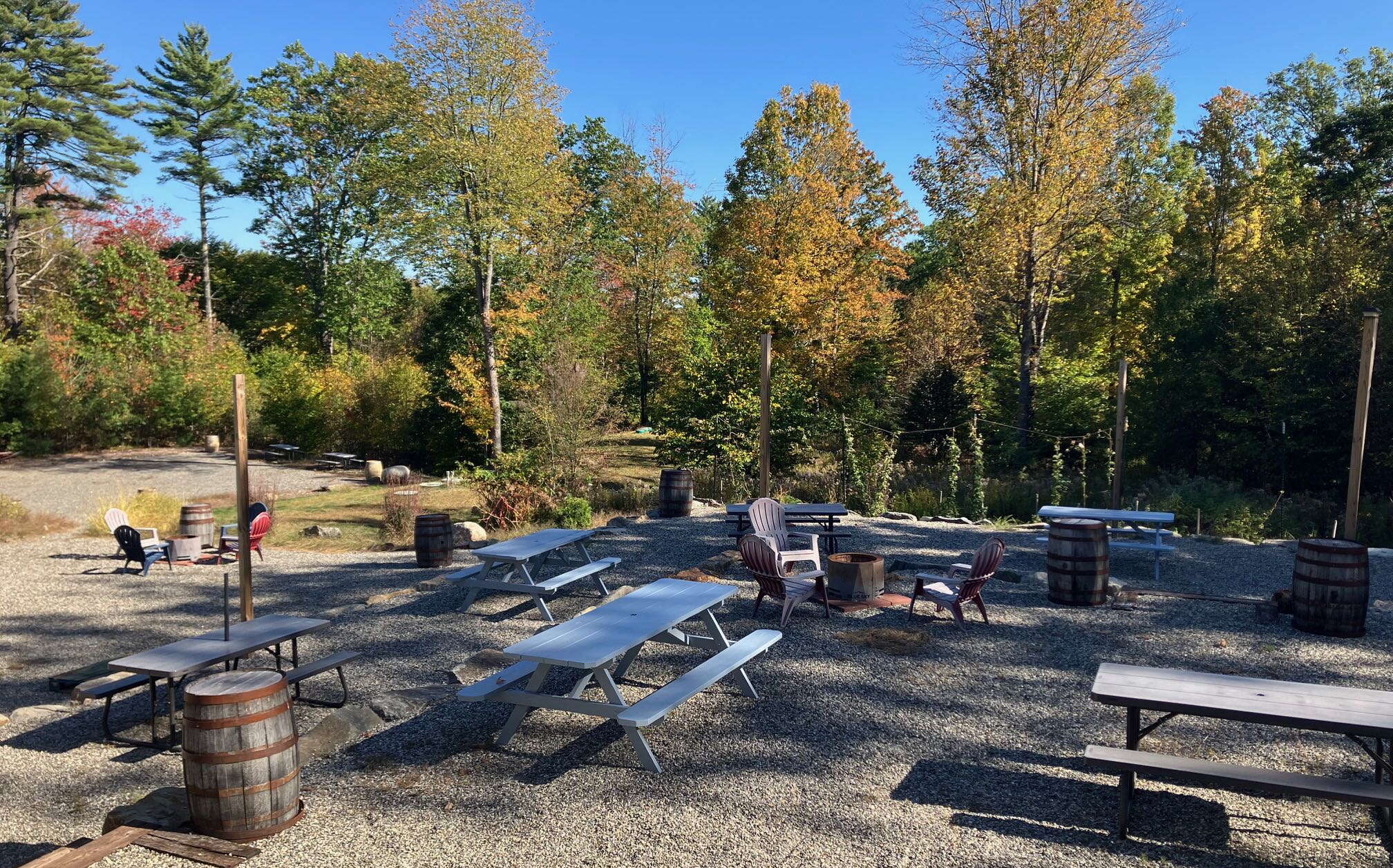 A gravel area outside has picnic benches.