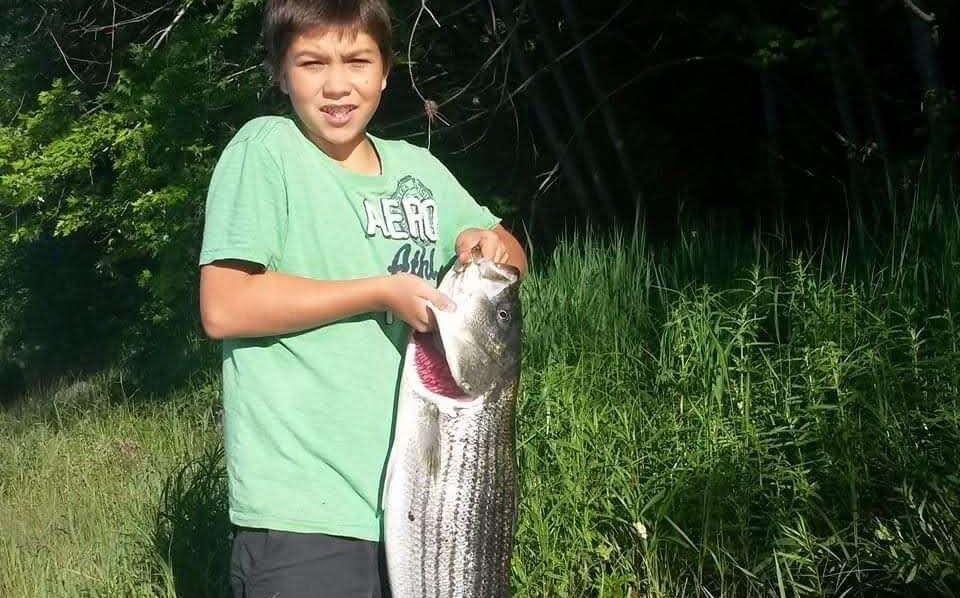 A child holds sa fish.