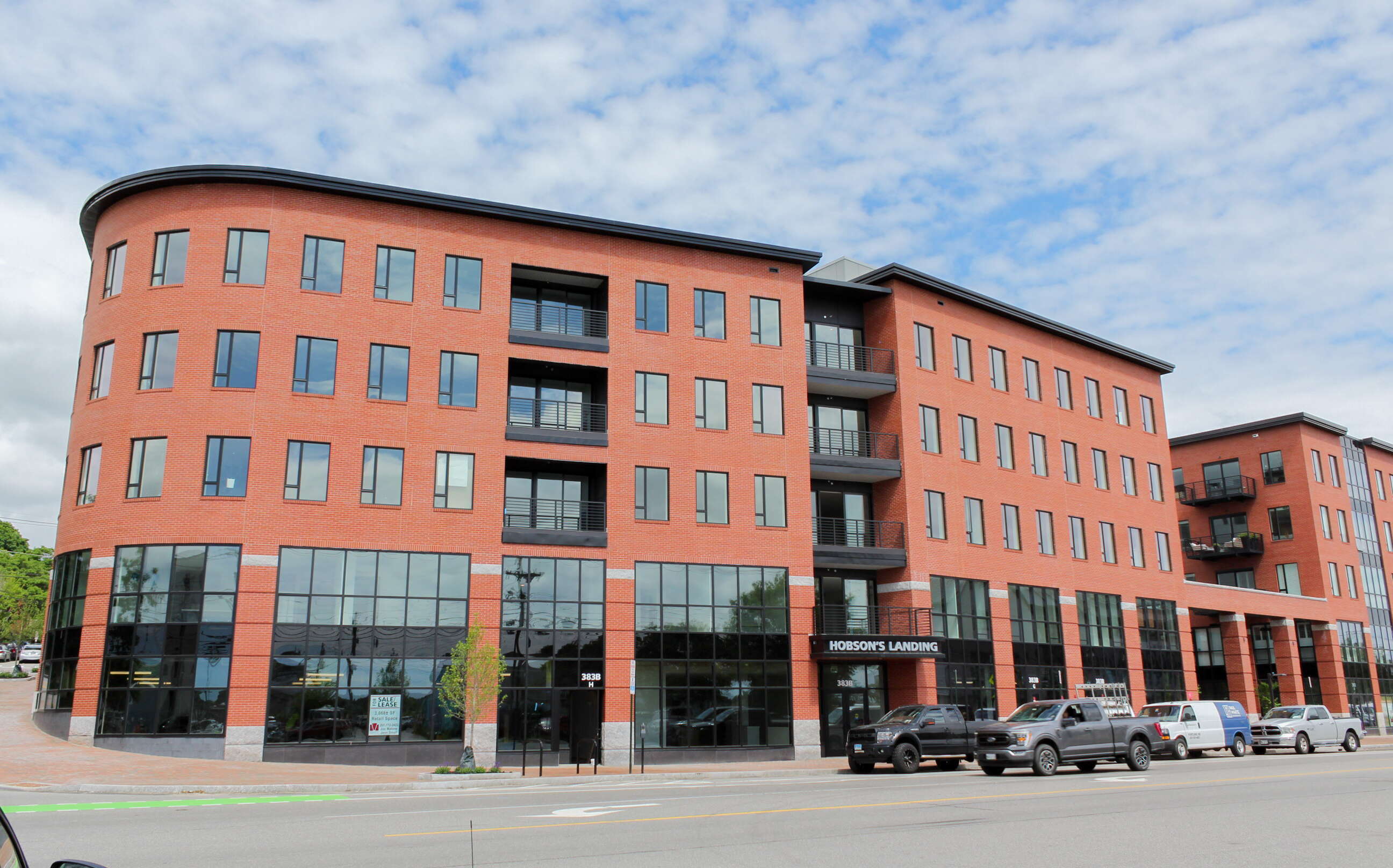 An exerior view shows a brick building with lots of windows.