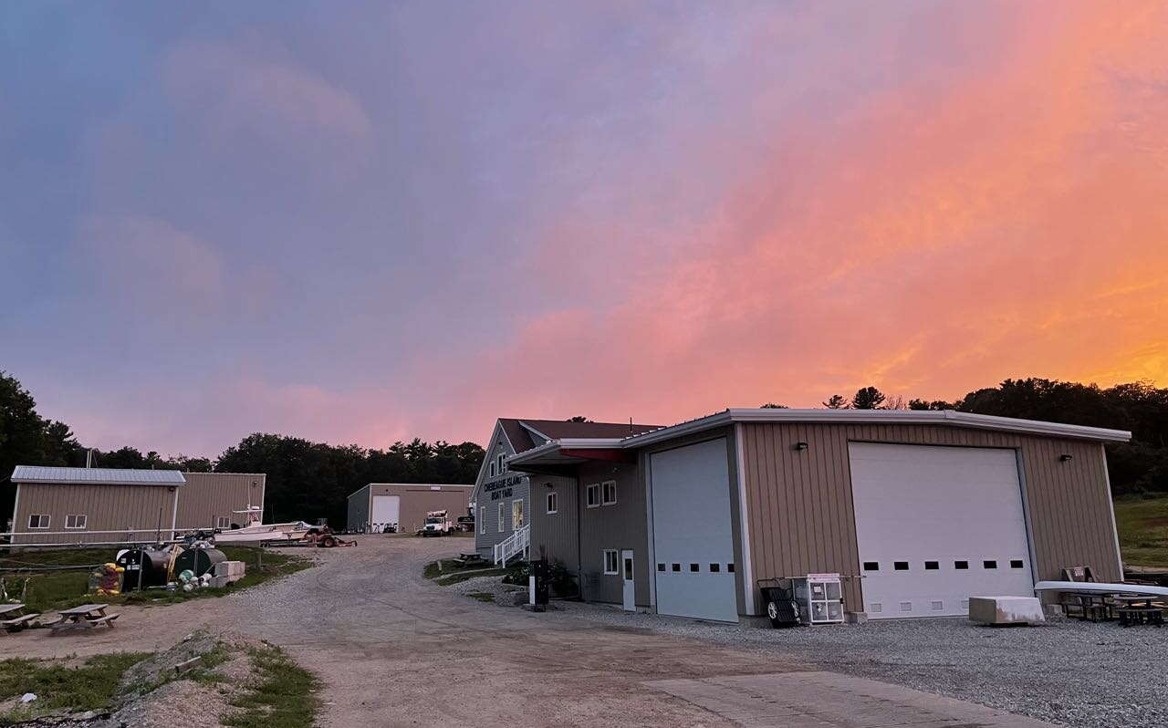 A sunset sky is over some buildings.