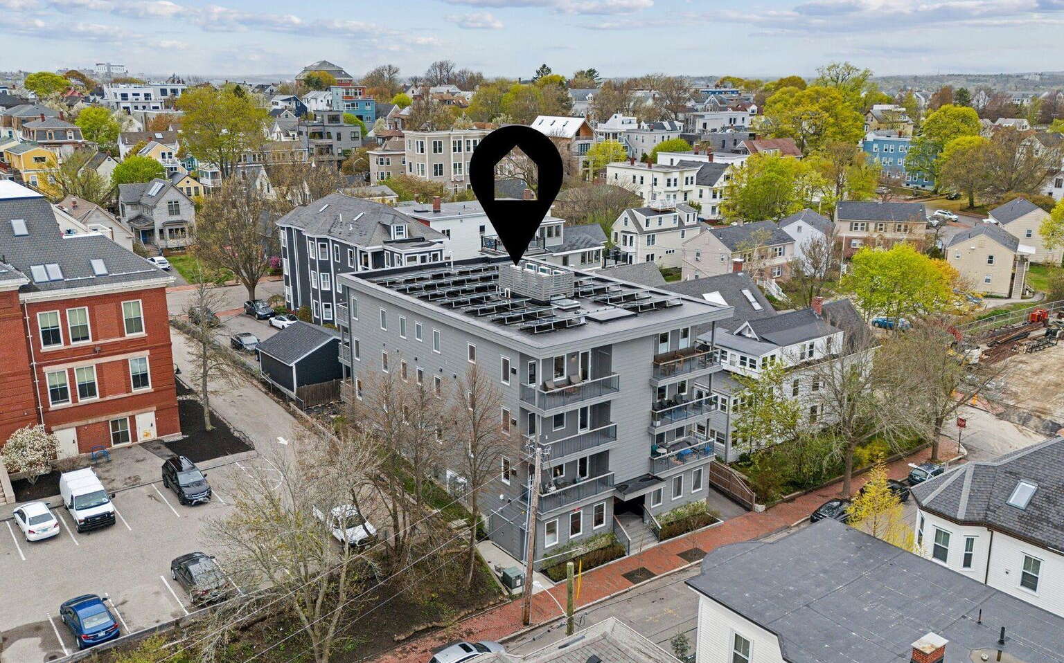 An aerial view shows a number of buildings and streets.