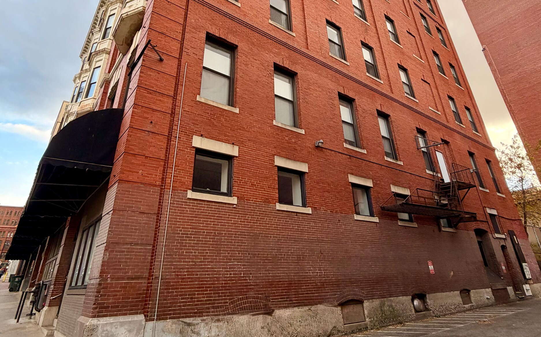 The exterior of a brick buildng, looking up.